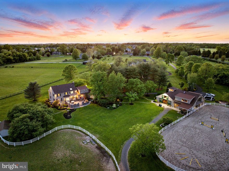 Welcome to Brookview Farm, an exceptional equestrian estate nestled on over 13 picturesque acres in the heart of historic Bucks County. This meticulously maintained property offers a rare blend of luxury, functionality, and income-generating potential within a private, serene setting just minutes from top-tier amenities, shopping, and dining. The elegant, updated residence features a newly added master suite complete with a luxurious master bathroom, a custom walk-in closet with built-in cabinetry, and stunning design details throughout. The home boasts granite countertops, hardwood flooring, and new Andersen windows, blending timeless elegance with modern convenience. Every inch has been thoughtfully cared for, including monthly pest control, to ensure a home of exceptional quality and comfort. Step outside to your private oasis, where a hardscape patio with a fully equipped outdoor kitchen, large gas fire pit, outdoor television, and professionally designed landscaping await. Bluestone walkways, mature trees, and well-manicured garden beds create an idyllic space for entertaining or relaxing. For equestrian enthusiasts, the property offers a state-of-the-art 7-stall barn, complete with a tack room featuring a kitchenette and restroom, and an overhang measuring approximately 24x36 for covered convenience. There is a very large sand outdoor riding area just steps away from the barn.  The estate includes 4 fenced pastures, each with run-in shelters and automatic waterers, as well as a sprinkler system for the grounds. Horse boarding generates a steady income, making this property a savvy investment as well as a dream home. Practicality meets luxury with a backup generator, which ensures uninterrupted power to both the home and barn. The property qualifies for Bucks County's ACT 319 agricultural tax benefits, significantly reducing property taxes while preserving its natural beauty. Beyond the gates, you'll find an ideal location: Warrington Township parks, Delaware Valley University, and top-rated Central Bucks South High School are all within easy reach. Despite its unmatched privacy, the estate is just minutes from bustling amenities, providing the best of both worlds. A charming creek winds through the property, further enhancing the tranquility of this one-of-a-kind estate. Brookview Farm is more than a home—it is a legacy property where elegance and functionality combine with the timeless appeal of country living.