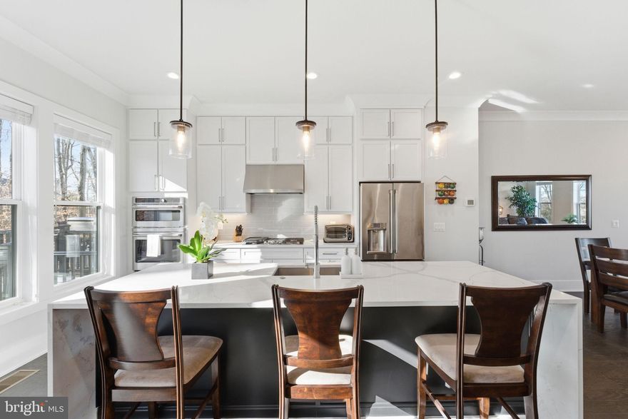 14661 Battery Ridge Ln is a transitional-style interior unit located in "The Enclave at Sully Station," a development by Premier Homes Group LLC. Built in 2022, the property combines modern architectural design with a highly functional layout. Enjoy hardwood floors on all three levels and 9ft ceilings with an open floor plan designed for entertaining and relaxing. With an East/West orientation the home has optimal natural light flowing into it. The main level has a view of the gorgeous, newer, single-family homes across the street and a buffer of trees for privacy from the rear deck. The floorplan of the home is ideal with great site lines on the main level with thoughtful placement of storage, & the powder room, along with a second large rec room in the basement, access to the backyard, and wide hallways, making the townhome live and feel more like a single-family home.  Convenience is what this home has with a Centreville location close to commuter routes 29 & 66, and access to express lanes.  Close to Dulles Airport without being "too close" as well as down the street from retail for your daily needs. Don't miss the listing video, this is the home you have been waiting for!  Welcome & Enjoy!