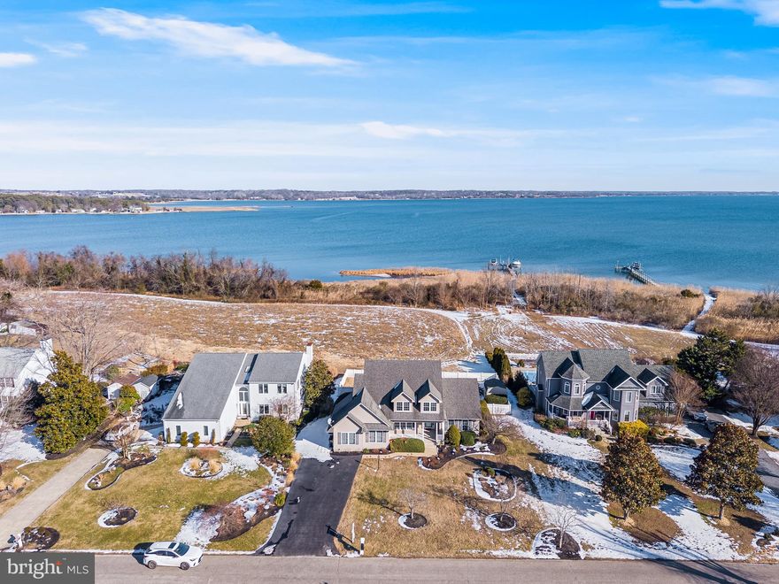 Live every day like you're on vacation. Wake up and wind down with stunning views of the Patuxent River from both your front and backyard. As you reach the end of Broomes Island Road, a sense of peace immediately sets in, surrounded by water views that continue the moment you step through the front door. Inside, the foyer welcomes you with hardwood floors throughout the main living areas, oversized windows flooding the home with natural light, and a dramatic two-story entry and living room. The natural light throughout this home is truly breathtaking. The open floor plan flows seamlessly into the dining room, featuring custom built-in shelving and cabinetry, an oversized window, and easy access to the spacious kitchen. Designed for both function and entertaining, the kitchen offers abundant cabinet and counter space, a butcher block island, tile backsplash, stainless steel appliances, and a separate beverage fridge. Unwind in the screened-in porch, the perfect spot to relax at the end of the day, overlooking your flat, fenced backyard, paver patio, and sweeping views of the Patuxent River. A rare and highly desirable feature, the owner’s suite is located on the main level. This generously sized room showcases LVP flooring, a walk-in closet with built-in shelving, and a spa-inspired en suite bath complete with a jetted soaking tub, tiled shower, and dual vanities. Upstairs, brand new carpet leads to two spacious bedrooms, a shared full bath, and a charming reading nook overlooking the foyer. The views are even better from this level! The garage has been thoughtfully converted into a fully conditioned flex space with a mini-split system, utility sink, and fresh epoxy flooring, perfect for a gym, hobby room, or additional storage. Opportunities to enjoy Patuxent River views at this price point are rare!