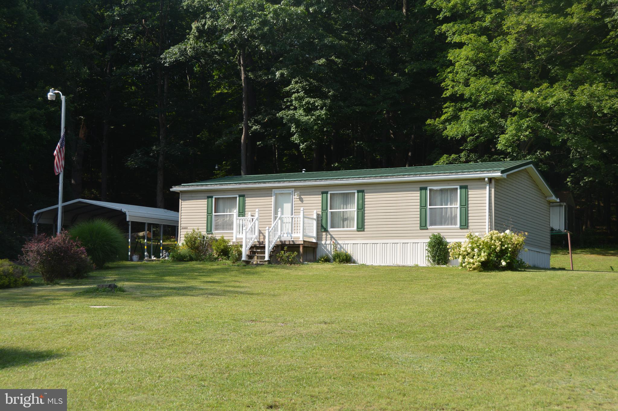 VERY UNIQUE PICTURESQUE PROPERTY - 3 BDRMS- 2 FULL BATHS WITH PRIVATE PRIMARY BDRM BATH - OPEN FLOOR PLAN - METAL ROOF - PRIVATE LOCATION - LG 1.86 ACRE LOT - COVERED PATIO - DETACHED CRAFT BUILDINGS - BACKS TO TREES AND PLENTY OF LANDSCAPING