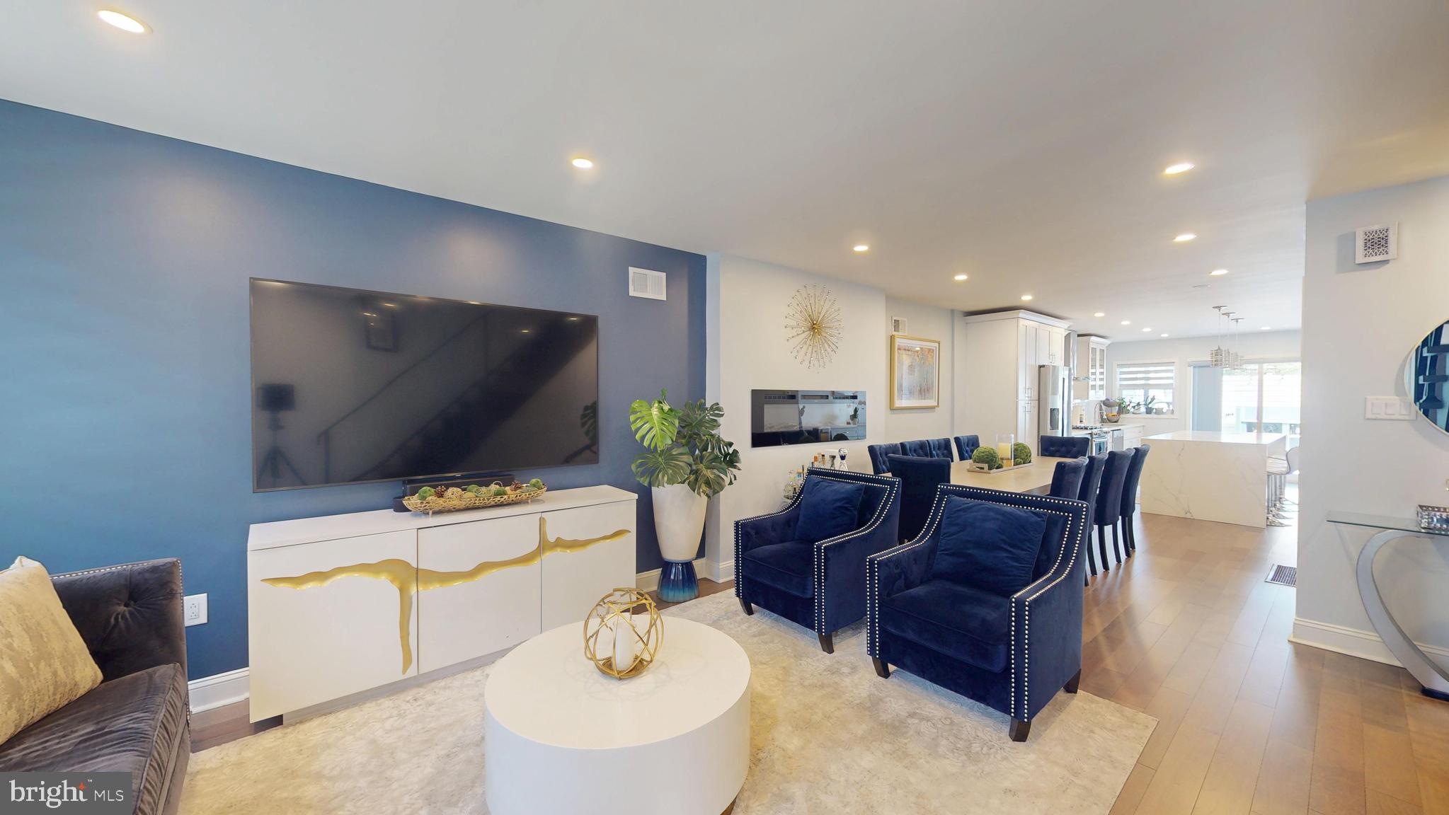 Introducing 2025 Ellsworth Street! This modern, spacious and sophisticated home impresses immediately.
Completely renovated with its modern design and high-end finishes boasts luxury and comfort. Enter into an open concept living room, dining room, powder room and Chef's kitchen, equipped with top-of-the line stainless steel appliances, custom cabinetry and countertops. The kitchen extends to a private, large yard, an oasis or perfect for entertaining. Walk up to the second level which has two spacious bedrooms, a modern 3 piece bathroom and full sized laundry. The third level and principal bedroom suite boasts elegance with an electric wall unit fireplace and a custom built walk-in-closet. This level suite has a striking bathroom with large double sinks, large jacuzzi tub and oversized shower. Last you can ascend to your private roof deck to enjoy the views of Philadelphia's skyline. In addition a finished basement is the perfect place for your private gym.