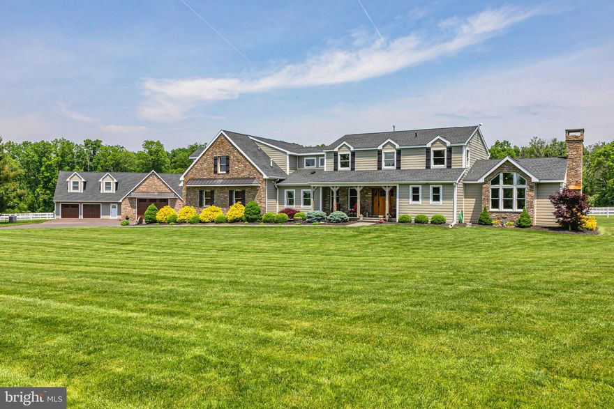 Pandora Stables, a private farm and verdant haven for horses and those who demand only the best. Situated on a scenic country road in Plumstead township, its long tree lined allee cuts a swath through lush green lawns worthy of a high end country club and arrives at the entry of an exquisite compound.  The main residence  whose keynotes are rustic, casual elegance was designed to be welcoming yet provide space for entertainment on a grand scale and offers bespoke comfort.  An open kitchen with professional appliances sprawls and is integrated with a great room with massive window walls overlooking pastures and mature tree line and has a wet bar and multiple television screens...there is no better sports bar than right here at home.  A dining area sits midway between this wing and massive living room with lodge style stone floor to ceiling fireplace and continuated walls of glass. The second floor holds an open sitting room, a main bedroom suite, soft and serene in diffused light, enjoying  a bath with the essence of a rainforest, highlighting organic materials.  Down the hall are two other bedrooms each with en suite bath.  Let's talk about the farm starting from the ground up....no expense was spared in its underground drainage system (including all paddocks, riding ring, 2 swales and a water basin). The larger barn has 8 12x12 stalls, large tack room, 12x12 wash stall. wash up room with deep sink and hot water heater, feed room, concrete walkways and 3 dry paddocks.  The entire barn is insulated, hay loft is wired, insulated, framed and prepped for another apartment).  An additional barn is heated and has 4  13x13 stalls (1 with a drain), a 16x16 dry outdoor paddock, large tack room and storage area for feed/hay, roll up weather tight garage doors, half wood barn doors and a full monitored fire system. A 100x200 outdoor riding ring with rubber and sand footing has a storage shed for jumps and 8 large LED lights.  a 16x16 storage shed and a sawdust shed building and many other features make this a turn-key facility.  The carriage house offers garage parking for at least 7 more vehicles on  porcelain tile floors, a car lift, a 12x25' loft with a wet bar and TV area and workshop; the ultimate "man cave".  Its second floor served by a separate entrance and electric meter is an apartment offering 2 bedrooms, kitchen, full bath and laundry.  Presently, boarders in 8 of the stalls bring in approximately $62,000 annually. (low boarder fee of up to $650 per month, some do barn chores,  easily $800 market rate).  The current owners use 4 for their own horses.  With all the stalls to be rented out, yearly income from all 12  the potential income could be $115,000. The Carriage house apartment brings in $19,200 plus help with some farm chores from its tenant.  Pristine, brilliantly thought out and beloved by all who know it, Pandora Stables is tricked out, jacked up and a pristine equestrian dream.  PLEASE CHECK OUT THE DRONE VIDEO AVAILABLE IN LINKS ABOVE IMAGES.