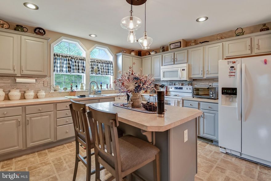 Welcome to 173 Random Road in Douglassville, a standout home in the highly sought-after 55+ community of Douglass Village. This beautifully maintained former model home has been lovingly cared for by its original owner and offers the perfect combination of comfort, style, and easy living. Situated on a premium lot with no home directly across the street, you’ll enjoy added privacy and a more open, scenic view. Designed for those who appreciate simplicity without sacrificing space, this 2-bedroom home offers a smart, low-maintenance layout that is easier to furnish, easier to clean, and more affordable to heat and cool than many larger homes in the community. For buyers looking to downsize, travel more, or simply enjoy a more manageable lifestyle, this home delivers all the right advantages. With less unused space and lower overall upkeep, you can spend more time enjoying your home and the community amenities instead of maintaining extra rooms you may not need. Inside, you’ll find luxury vinyl plank flooring throughout, along with upgraded light fixtures and ceiling fans in the living room, both bedrooms, and even the front porch. The open floor plan creates a spacious and inviting feel, while the kitchen offers abundant cabinetry and countertop space, a custom tile backsplash, recessed lighting, a gooseneck faucet, an island, and a new glass-top electric stove. Both bathrooms have been tastefully remodeled, and the dedicated laundry room provides convenient interior access to the attached two-car garage. Outside, the professionally landscaped exterior adds to the home’s already impressive curb appeal. Additional highlights include natural gas forced-air heat and central air conditioning for year-round comfort. Lot rent includes lawn care, snow removal, trash service, access to the community pool, health club, recreation facilities, and maintenance of common areas. This is a wonderful opportunity to enjoy low-maintenance living in one of the area’s most desirable active adult communities. If you’ve been looking for a home that offers comfort, efficiency, and a more carefree lifestyle, 173 Random Road is one you won’t want to miss.