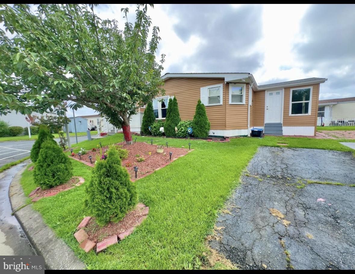 3 MONTHS FREE GROUND RENT!!! RARE HARD TO FIND DOUBLWIDE WITH LARGE ALL SEASON ROOM WITH HEATING AND AIR WITH A DOG BATH. OPEN FLOOR PLAN WITH DINING ROOM AND LIVING ROOM WITH A FIREPLACE. LARGE KITCHEN WITH PLENTY OF CABINET SPACE WITH GRANITE COUNTERTOPS . LARGE EATING AREA OFF THE KITCHEN. HOME ISTS ON A CORNER LOT AND ACROSS THE STREET IS AN OPEN AREA AND DOG PARK. THIS HOME IS A MUST SEE!!!