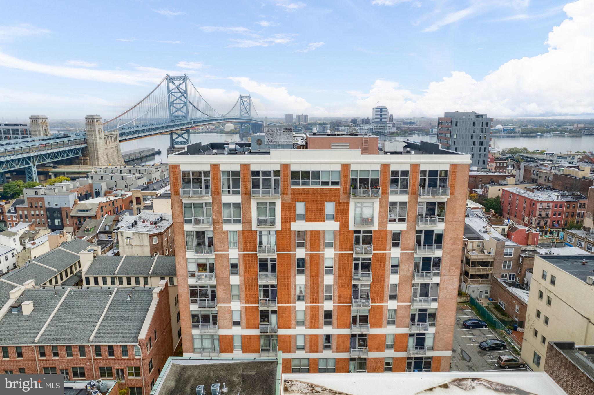 Absolutely stunning west facing 2-bedroom, 2-full bathroom condo at The National Condominiums, deep in the heart of historic Old City. Gaze at the towering loft-style exposed concrete ceilings and wall-to-wall hardwood floors. Unit features a foyer with closest, laundry and a full hallway bathroom. A spacious kitchen with 42" cabinets, granite countertops, bar counter seating and stainless steel applicates makes for the ideal cooking arena. Large living room area features floor-to-ceiling windows allowing for ample natural light; notice the exposed duct work for an industrial touch. Walk out onto the balcony with unobstructed views of the Center City Philadelphia skyline. Guest bedroom doubles as an office space. The owner's suite with more views of the city skyline is fitted with brand new luxurious carpet and holds a large walk-in closest w/ custom organizers and a en-suite bathroom sporting a double vanity with granite countertop and shower stall. This includes a deeded garage parking stall. The National Condominiums is a private gated community with common outdoor space and secure entry. You are just a few minutes walk away from dozens of notable restaurants, bars, shops, galleries, historic Elfreth's Alley, Christ Church and the Race Street Pier. Truly the perfect place to fall in love with the Old City lifestyle.