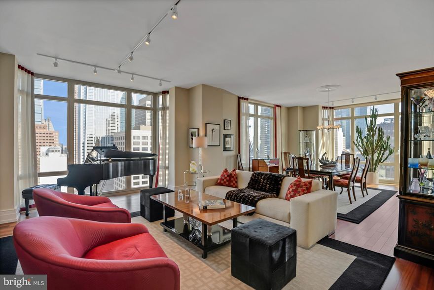 Imagine living in a stunning residence at 10 RITTENHOUSE on a Goldilocks chosen floor (JUST RIGHT) for the best views. 2 bedrooms, a DEN, 2.5 baths and a BALCONY overlooking Rittenhouse Square. 2,588 square feet in the fabulous Rittenhouse Square neighborhood ON THE SQUARE. Includes one GARAGE PARKING License and one STORAGE unit. 
Enter into a foyer to a beautiful gallery. Through the gallery walk to the main living area with wonderful skyline views to the north seen through oversized windows. A grand wide living room and dining room space is emphasized by high ceilings. The dining room faces east with the floor to ceiling bay window bringing the sky right in. Light bounces off the gleaming wood floors.
From the dining room is one of the entrances to the large beautiful kitchen and family room. Natural toned Poggenpohl cabinetry, light granite counter tops, light glass backsplash, an island with a large sink, more cabinetry and barstool seating. Casual 'everyday dining’ table space warmed with the light from the large east facing window. Sub Zero refrigerator, Miele Dishwasher, Miele Oven, Viking 5 burner gas stove,
Powder room.
On the other side of your residence are the bedrooms and the den. The primary suite with doors opening to the covered balcony is great for your evening cocktail or morning coffee. Your own private outdoor space. The marble primary bath is extra large with tub, oversize shower, water closet, double sinks, storage cabinets, linen closet. Second bedroom has a pretty ensuite bath. The den/home office/‘grandkid sleepover’ room is a useful bonus space. Custom walk in closets. 10 Rittenhouse was designed by renowned architect Robert A. M. Stern who also designed The Comcast Center, The Ritz Carlton Dallas, The George Bush Presidential Center and so many other extraordinary buildings. 10 is known for distinctive service, its beauty and luxurious amenities including 24 hour door staff, dedicated concierge desk staff, excellent on site management, chauffeured driven town car, indoor lap pool, outdoor sunning area, yoga room, hotel guest suite, a wine room, fitness center, the luxurious Rescue Spa, library room, bicycle room, piano room, tv lounge, catering kitchen and board room.  Walk Score 100. Please click Icon for video.