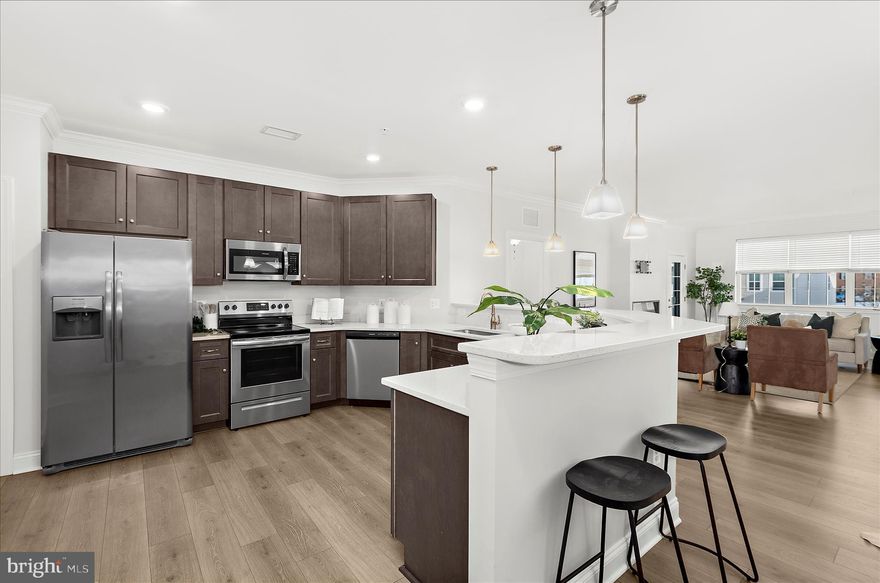 Freshly painted condo in the highly desirable Overlook at Gateway, backing to the Ma & Pa Heritage Trail. This secure building offers peace of mind and includes two garage parking spaces — with no snow cleanup on your car or exterior to worry about.

The home features an open layout with 9-foot ceilings, crown molding throughout, LVP flooring, and a low electric bill. The kitchen is equipped with 42" maple cabinets with soft-close hardware and stainless steel appliances. The living area is enhanced by an electric fireplace with color-changing features and opens to a private balcony.

The owner’s suite includes double closets, and the unit offers the convenience of in-unit laundry. Additional highlights include custom vinyl blinds and a fire sprinkler system.

Building amenities include a secure mailroom, double elevators, and this home is located within a well-maintained 55+ community. Water is included in the HOA fee, adding to the ease of ownership. Convenient access to walking trails, shopping, and everyday amenities.