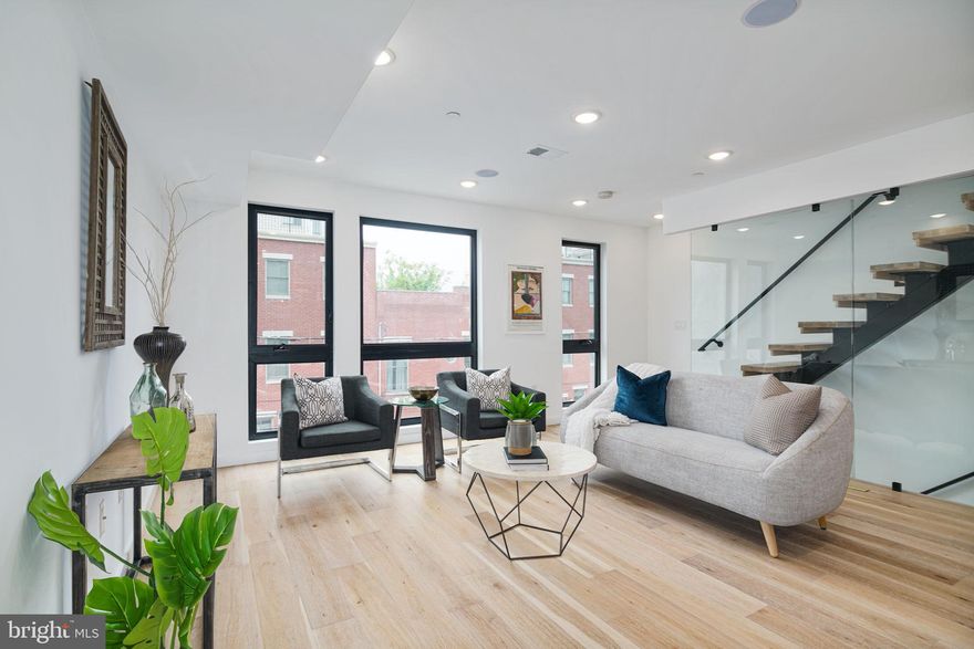 Welcome to 871 N 20th Street! This 3 year young building with high-end luxury finishes consists of 3 condos and is located in the heart of the Francisville/Fairmount neighborhood. Unit 3 is a  20 feet wide, tri-level unit with private rooftop deck and unobstructed Center City views. Upon arrival into Unit 3 you will enter into the lower level of the condo which includes 1 spacious bedroom and full bathroom. Walk up the stairs to the main living space and immediately notice the hardwood flooring and recessed lighting throughout. The stunning chef's kitchen features a beautiful large island with barstool seating and stainless steel appliances. Up the beautiful floating staircase with glass wall, the top level is home to the primary bed and bath with access to the large rooftop with city-wide views. This luxury condominium comes with a 7 years remaining on the tax abatement! 871 N 20th Street is in close proximity to The MET Philadelphia, Eastern State Penitentiary and steps from all that Fairmount Avenue has to offer. Schedule your tour today!