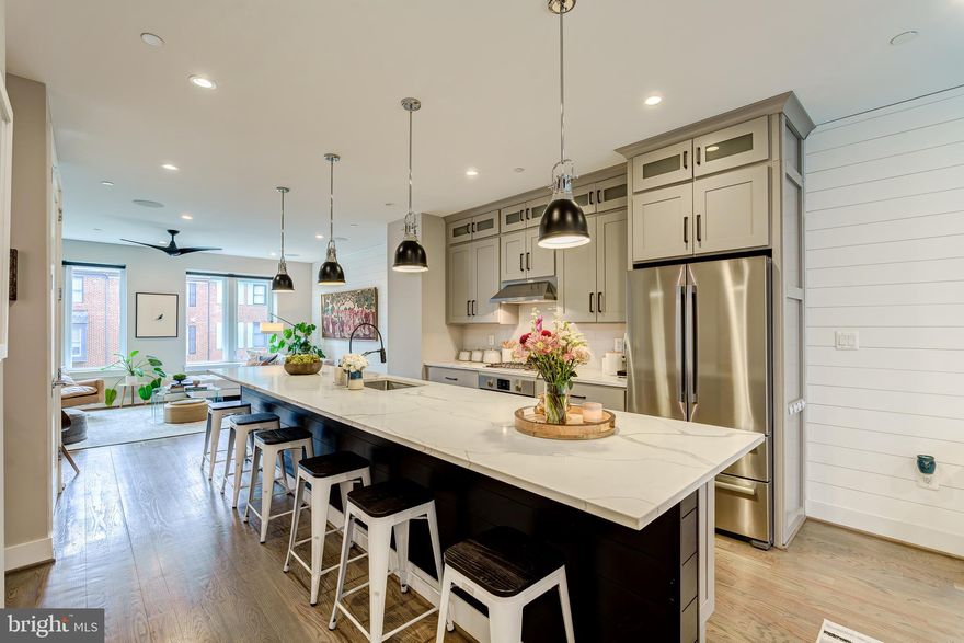 Tucked within a private enclave in Old Town Alexandria, 605 Slade Court is a modern masterpiece offering a rare blend of tranquility and urban convenience. Shielded from the traffic of Richmond Highway and Pendleton Street, this stunning contemporary home is part of a peaceful, manicured courtyard—perfect for play or quiet relaxation. Spanning four stylish levels, this sleek, light-filled home boasts high ceilings, wide-plank hardwood floors, and a thoughtfully designed open-concept layout perfect for both everyday living and sophisticated entertaining. The entry level opens to a spacious den—ideal as a home office or cozy library. The main living level impresses with its expansive great room, anchored by a chef’s kitchen featuring a massive 16 ft center island with breakfast bar seating, stainless steel appliances, soft-close cabinetry, and a walk-in pantry. The seamless flow from kitchen to dining to living room is tailor-made for gathering with friends and family. Upstairs, the primary suite is a luxurious retreat with two custom-designed closets and a spa-like ensuite bath - complete with a double-sink quartz vanity and glass-enclosed walk-in shower. A second bedroom with its own ensuite bath and a full-size closet complete this level. The top floor offers a third ensuite bedroom and a flexible loft space with a wet bar and wine fridge, perfect for game nights or quiet evenings. Step outside to your private rooftop terrace—a serene setting for sunset views or alfresco dining. Additional features include a two-car garage with built-in storage, integrated Sonos sound system, Shade Store electronic blinds, August smart lock, Nest thermostat, and Trinity alarm system. Location? Unbeatable. A short stroll to King Street, the waterfront, Braddock Road Metro, and a host of restaurants like Mason Social, Bastille, Chewish Deli, and Hank’s Oyster Bar. Close to Reagan National Airport, GW Parkway, Amazon HQ2, and the Virginia Tech Innovation Campus. 605 Slade Court offers the ultimate in private, city living. Come experience this rare opportunity to live tucked away—yet right in the heart of it all.