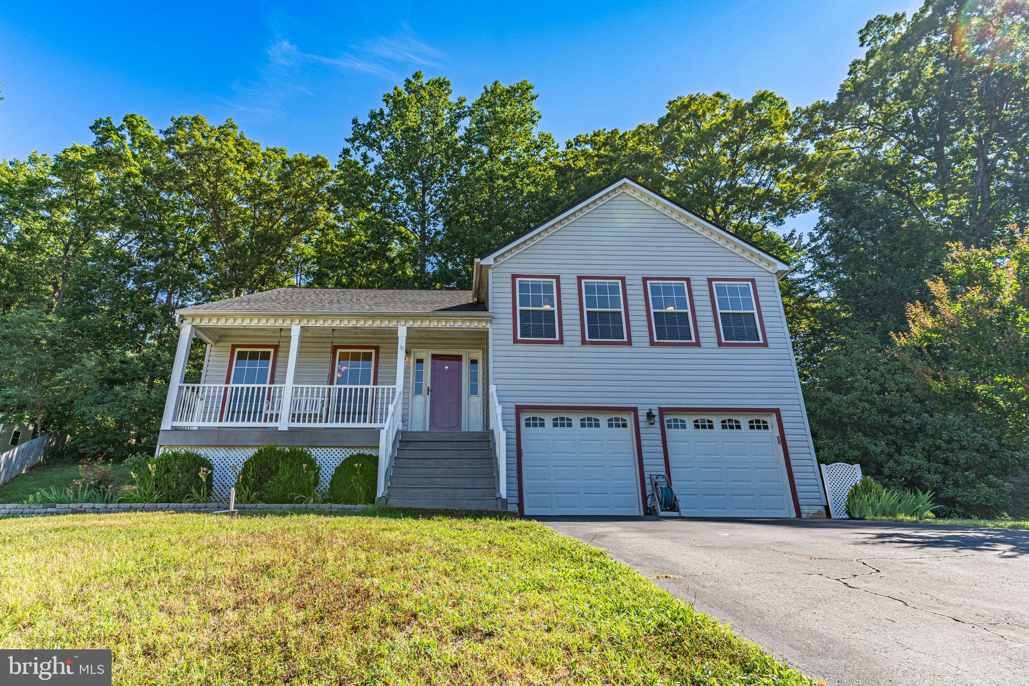 This gorgeous, well-maintained home features an open floor plan, a charming front porch, a two-car garage, and is located in a comfortable neighborhood only minutes away from Route 1, I-95, Quantico Marine Base, shopping centers, restaurants, and numerous state parks and hiking trails.
The spacious kitchen boasts stainless steel appliances, vaulted ceilings, and recessed lighting. The dining room, with its vaulted ceiling, overlooks the stunning hardwood-floored, 2-story living room. The primary bedroom offers a private bath and walk-in closet. Enjoy a huge rec room that features a gas fireplace and recessed lighting. Step outside to a deck and impressive stamped concrete patio that overlooks a large, private cul-de-sac lot.
Recent updates include a new roof in 2017, HVAC replacement in 2019, and new kitchen flooring in April of this year. Don't miss out on this incredible home it won't last long!