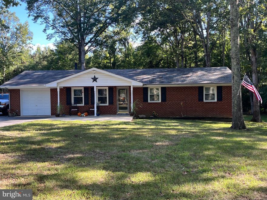 Welcome home! This all brick rambler on over one acre can be your next home to enjoy.  Located on a no-through street and backs to woods just outside of La Plata town limits=all the benefits of town living but no town taxes!  This home has been updated and has crown moulding,  newer appliances and AC.  The exterior  of the home has electric supply for an RV or whole house generator and two cold and hot water spigots!   There is even an outlet  on the roof overhang on a timer so that you don't have extension cords all over the place when you hang your holiday lights. The back yard is lined by trees and has a large deck for entertaining, with space for 15+ cars on the paved driveway, No one will have ever have to park on the street. If basketball, street hockey or pickle ball are your thing, this driveway will give you the space.   Come take a look and you can be in your new home for the holidays!
