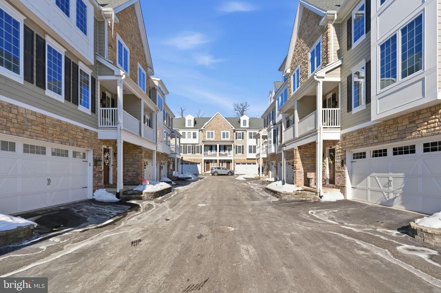 Welcome to 23 Grey Court – refined, low-maintenance luxury living in the heart of Berwyn.
Built just a few years ago and meticulously maintained, this stunning 3,300+ sq ft townhome offers four finished levels of sophisticated, sun-filled living space with the perfect blend of modern design, high-end upgrades, and everyday convenience.
Step inside from the welcoming front entrance or attached 2-car garage and you’re greeted by rich hardwood floors and a bright, versatile lower level. Ideal as a private home office, guest suite, or fourth bedroom, this level also features a full bath, laundry room with sink, generous storage, and walk-out access to a peaceful paver patio.
Upstairs, the main living level was designed for both entertaining and comfort. The open-concept layout showcases a gas fireplace, coffered ceiling, and private balcony for morning coffee or evening relaxation. The chef’s kitchen is a true showpiece, complete with an oversized marble island, honed anthracite granite countertops, dolomite marble backsplash, custom cabinetry, upgraded range exhaust fan, and premium finishes throughout. A light-filled dining area with crown molding and a stylish powder room complete the space.
Retreat to the luxurious primary suite featuring a sitting area, multiple closets, and a spa-inspired bath with marble-top bench, designer tilework, and rain shower. Each additional bedroom enjoys its own upgraded en-suite bath, offering comfort and privacy for family or guests.
The top level opens to a private roof deck — perfect for entertaining, relaxing under the stars, or enjoying sunset views.
Enjoy true lock-and-leave living with HOA services that cover landscaping, lawn care, and snow removal. Walk to Berwyn’s charming shops, restaurants, parks, and the YMCA, with easy access to both Daylesford and Berwyn train stations for effortless commuting.
Located in the highly sought-after Tredyffrin-Easttown School District, this move-in-ready home offers the best of Main Line living — style, convenience, and exceptional quality — all in one.

Don’t miss this rare opportunity to own nearly new construction in one of Berwyn’s most desirable communities.