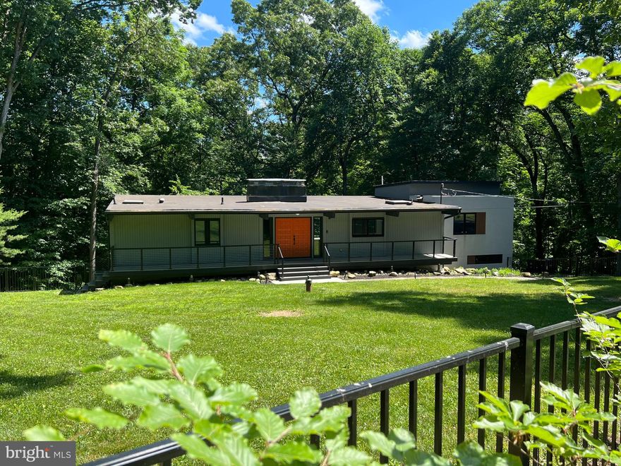 Great opportunity to own a fabulous home in T/E School District!   This home offers first floor living with a first floor primary en-suite with a slider providing access to a 500 sq ft deck.   Enjoy the tranquil location on the Valley Forge Mountain.  Meticulously maintained and move in ready, this mid-century modern home exudes modern elegance throughout offering a first floor primary suite, four additional bedrooms and three and a half baths, an open floor plan and indoor \ outdoor living. Completely updated with an addition in 2020 and most recently improved with all new white oak hardwood flooring, a newly finished mudroom, whole house generator, freshly painted walls, new modern light fixtures, recessed lighting throughout and a fenced front yard.  At the center of the home is a modern kitchen with quartz countertops, stainless appliances and large center island.  The open concept flow allows for beautiful tree-line views from the kitchen, spacious dining room and cozy family room, accented with a wood burning fireplace.  Floor to ceiling sliders bring the beauty of the outside in and allow for access to an entertainers dream deck offering multiple spaces to dine or relax enjoying the natural tranquility.  The recently renovated primary en suite is on the main level and offers a private slider to the deck and more amazing views!  A spa like en suite bath features a soaking tub, double sink vanity and double shower finished in marble tile – a true retreat!  Also, on the main level are two spacious bedrooms serviced by a perfectly finished hall bath as well as a beautifully detailed powder room.  The lower level features two more nicely sized bedrooms and another fully remodeled full bath.  Enjoy the cozy family room with a second wood burning fireplace. A newly finished mudroom space is available off of the family room and is accessed directly from the two car garage.  A perfect place to put your things down as you come home!  From the mudroom there is a semi-finished bonus room and a separate large storage room.  Move in worry free – this house also has a whole house generator fueled by propane.   Enjoy living in a tranquil yet convenient location situated on a private road with access to hiking that intersects the Appalachian Trail and just minutes from the R5 train line, downtown shopping and dining offered in Wayne, King of Prussia Paoli and Malvern.  Local amenities are available through the Valley Forge Mt Association and include community and social events, newly updated playgrounds and gazebo and pool membership options.