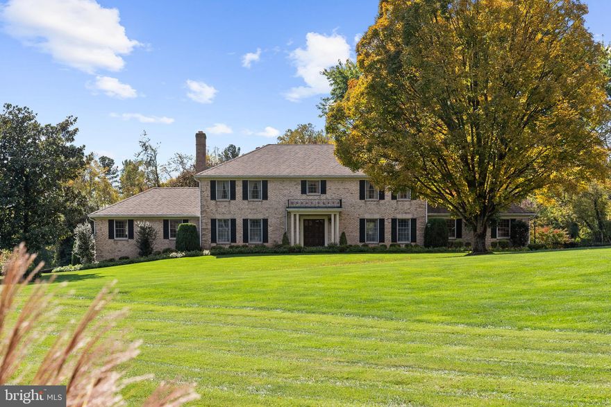 Positioned on an exceptional, five-acre estate parcel on the border of McLean and Great Falls, this classic brick residence offers a serene country setting just minutes from Tysons Corner, Reston, and downtown McLean. Built in 1972, the existing home spans approximately 3,953 square feet above grade with a full daylight basement, and features four bedrooms, four full baths, and one half bath.
Generously proportioned interiors are complemented by an enclosed porch, expansive wood deck, and covered portico, providing multiple spaces for outdoor living and entertaining. A 575-square-foot attached garage connects conveniently to the main level, while a 2,560-square-foot detached barn offers exceptional potential for a workshop, studio, or equestrian use.
The property’s 5-acre zoning offers a rare combination of privacy and versatility. Served by paved road access and surrounded by mature trees, this is an ideal opportunity for those seeking a buildable, estate-style parcel with existing infrastructure in a premier McLean/Great Falls location.