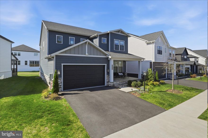 Welcome to 22773 Orchard Grove Drive. Nestled in the desirable West Park at Brambleton, this stunning contemporary 2 years young TriPointe residence built in late 2023 offers an exquisite blend of luxury and comfort. Many builder upgrades along with $100k post construction upgrades in 2024 by homeowner. Spanning 4,692 square feet, this meticulously crafted home features 6 spacious bedrooms and 5 elegant bathrooms, perfect for both relaxation and entertaining. Step inside to discover an open floor plan that seamlessly connects the gourmet kitchen, complete with upgraded quartz countertops and backsplash, custom lighting package, stainless steel appliances, and a generous island, to the inviting family room adorned with recessed lighting and a newly installed custom cozy electric fireplace. The main level also boasts an entry-level bedroom and full bathroom with a walk-in shower.  The spacious upper level offers 4 bedrooms and 3 bathrooms (all with upgraded walk-in showers and finishes, primary spa like luxury bathroom includes a separate soaking tub).  Custom primary bedroom closet system installed for ease and comfort. The fully finished basement, with walkout stairs, provides additional living space, ideal for a home theater or recreation area, and an additional bedroom with full bathroom. Enjoy the beauty of natural light streaming through double-pane windows, enhancing the home's inviting ambiance. For your enhanced convience and comfort this home has been outfitted with upgraded smart home automations to include light switches, thermostats, door lock and video doorbell, Bluetooth speakers in bathrooms,a and more.  Outside, the property is beautifully landscaped with recently installed underground irrigation system and WiFi controller, featuring a covered porch and rear yard perfect for outdoor gatherings. The 2 car garage has been upgraded with epoxy flooring and pre-wiring for EV charging. Relax on the spacious front porch, and take advantage of the community amenities such as Brambleton Town Center, including a pool, dog park, and bike trails. Conveniently located in a suburban setting, this home is just minutes from commuter lots, Ashburn metro stations, and Dulles International airport, ensuring easy access to local amenities and beyond. With an attached garage and ample driveway parking, this residence is a true gem in a vibrant community. Experience the perfect blend of luxury and lifestyle in this exceptional home.  Don’t miss this incredible opportunity to own this upgraded 2 year young “better than new” residence without any construction delays and best of all no rent back needed allowing for a quick move-in!