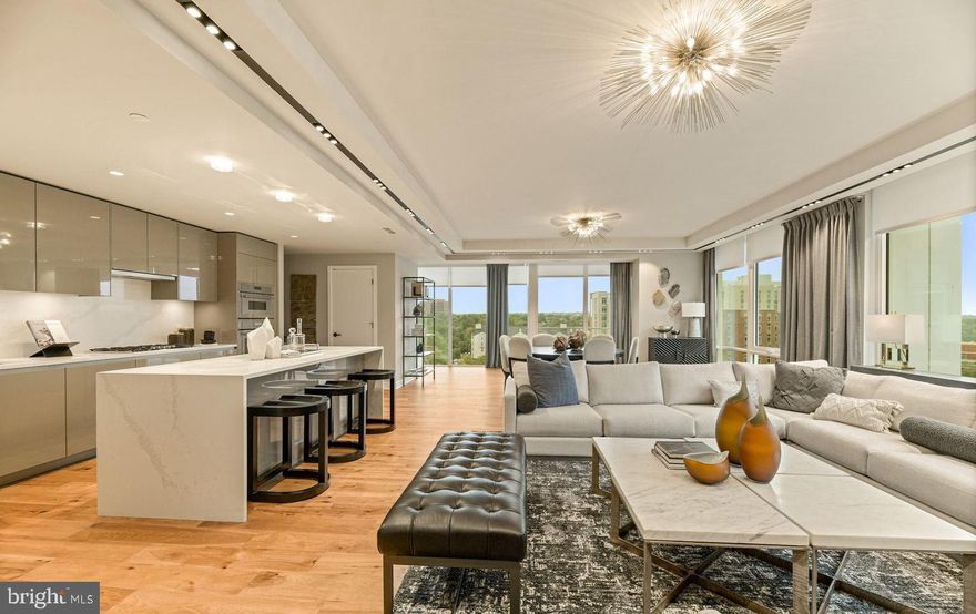 Enjoy the epitome of luxury in Rosslyn at Pierce Condominiums. This unit occupies the entire west end of the building, offering panoramic views through expansive windows. Featuring three bedrooms, two full baths, and one half bath.  The chef's kitchen is equipped with top-of-the-line Thermador appliances, a wine fridge, Snaidero cabinets, and quartz countertops with a waterfall island. The master bath provides a spa-like experience with heated  marble floors. Residents enjoy 24/7 white-glove concierge service, a double-level fitness center, and a rooftop club room with a pool. Enhanced privacy is ensured with direct elevator access. Experience unmatched luxury and convenience at this condo in Pierce Condominiums.