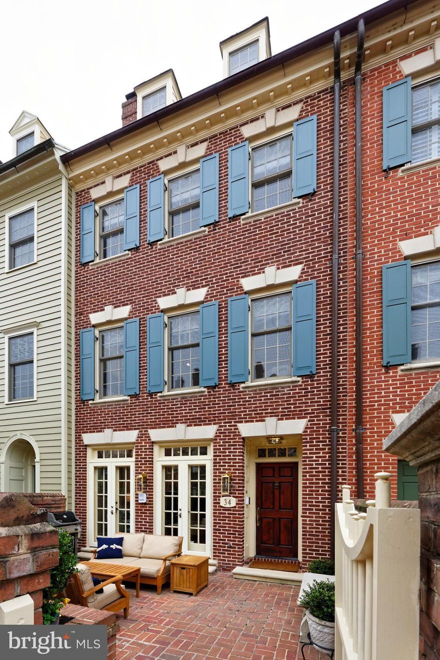 34 Wolfe Street at Harborside is an elegant residence with a contemporary edge for the selective buyer seeking truly distinctive living quarters in Old Town Alexandria.   This totally renovated, pristine home offers high ceilings, beautiful hardwood floors, detailed moldings throughout,  extensive built-ins, tall light-filled windows and doors plus 3 handsome fireplaces.   The living room with southern exposure is filled with natural light with French doors which open to the private terrace.   A library/home office adjoins the room with glass pocket doors and features custom built-ins suitable for today's technology needs.  The sunny chef's kitchen with new Jenn Air appliances is open to the family room/dining area which offers custom lighted cabinets and hardwood floors.   The spacious master suite occupies its own entire floor with a fireplace, hardwood floors, 2 California Closets and a brand new master bath with every convenience including a soaking tub, large walk-in shower, custom cabinetry and heated towel racks.   The top floor guest suite is spacious and bright with skylights.  An enormous closet on this floor can store sports equipment such as snow skis, hiking or fishing gear plus large items from your previous home.    Park your 2 cars in the garage immediately outside your back door, accessed by the interior Otis wood- paneled elevator which goes to all floors of this residence.   Enjoy the 35' boat slip in the Harborside Marina which conveys with this property.   Park your car and park your boat!   The infrastructure of this property has been completely renovated during the past 18 months with  2 new HVAC complete systems, a new roof, new circuitry board for the elevator and a new tankless hot water heater.   The owners of this special property have never used the dining room and master bedroom gas fireplaces, so those convey as is.   All 3 fireplaces are masonry construction and able to be converted to wood burning fireplaces if someone wishes.