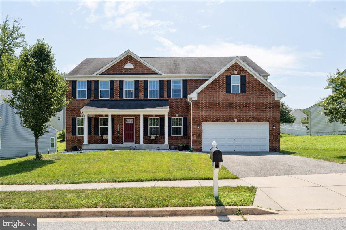 At nearly 5,000 square feet of refined living space, this stately brick-front home is designed for those who will not settle for anything less than comfort, elegance and room to grow. Perfectly positioned in a picturesque, well-maintained community, this residence offers a lifestyle of effortless sophistication just minutes from the vibrant energy of the National Harbor, Old Town Alexandria, and Washington, DC.
From the moment you step into the welcoming foyer, you're greeted by the rich warmth of espresso-finished hardwood floors, flanked by a formal living room and a separate dining room—ideal for elevated entertaining and elegant gatherings. The heart of the home is a sprawling great room that flows seamlessly into a chef’s kitchen outfitted with modern finishes: mahogany cabinetry, granite countertops, stainless steel appliances, an oversized island, breakfast bar and a large pantry fit for the most ambitious culinary pursuits. Bathed in natural light, the sunroom-style breakfast room is the perfect place to start your day. Also on the main level a versatile office or den, perfect for remote work, and a beautifully appointed powder room for guests.
Upstairs, retreat to the luxurious owner's suite, complete with a spa-like en suite bathroom and a massive walk-in closet. Four additional generously sized bedrooms, a full hall bath and a bedroom-level laundry room ensure both comfort and convenience for every member of the household. The partially finished lower level offers expansive flexibility: a finished recreation room ready for game nights or movie marathons, a dedicated home gym space, and abundant storage or transform these areas into a home theater, additional bedrooms or an in-law suite. The options are endless. Outside, enjoy quiet moments on your covered front porch, host gatherings on the composite rear deck and take full advantage of your attached 2-car garage and beautifully landscaped surroundings. Whether you're entertaining guests, working from home or simply relaxing in refined comfort, this home checks every box and then some.
