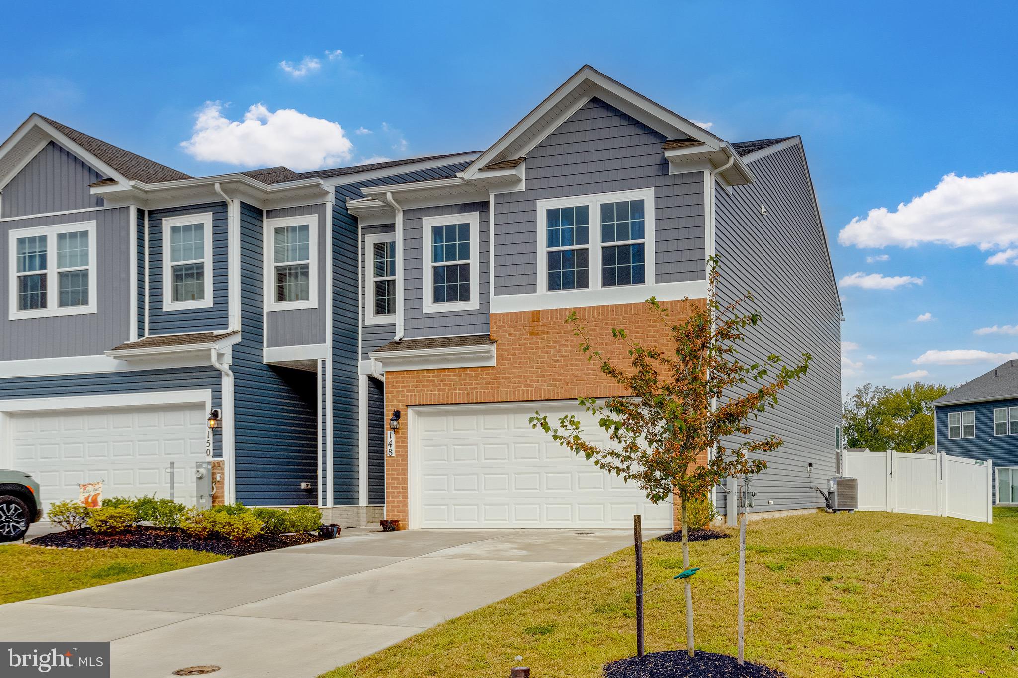 Welcome to this gorgeous 4 bedroom, 2.5 bath, 2 car garage end of group home in Greenway Farms, just built in 2023! This home stands out because it comes with a fully fenced rear yard on one of the largest cleared lots in the neighborhood. Walking into the main level brings you to a floor with luxury vinyl plank flooring throughout, as the front hallway opens up into an open concept area with living room, dining and kitchen. The luxury kitchen has custom cabinetry, quartz countertops, backsplash, all new stainless appliances and a large quartz island overlooking the living area. Sliders off of the living room open out into the large fully fenced rear yard with high privacy fencing. Also on the main level is a convenient powder room and access to the two car garage. Taking the stairs to the carpeted second floor brings you to a loft area, and a full bath with tub/shower combo as well as four bedrooms. One of these bedrooms is the primary suite with its own large private bath with quartz double vanities, a walk in shower and a deep walk in closet. Also, on this upper level is a convenient walk in laundry room with washer/dryer. This house is new, luxurious and pristine and waiting for you! Sellers are gifting a one year home warranty to the lucky buyers! Come see why its the best one available, today!
