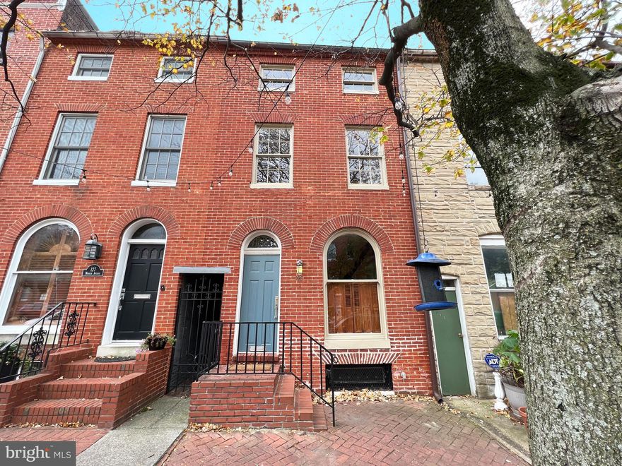 Historic District townhouse steps from Federal Hill Park and the Inner Harbor.  3 bed/2.5 bath home with parking. Full of character, natural light,  & hardwood floors throughout. This home boasts a gourmet eat-in kitchen with cherry cabinetry & stainless steel appliances. 1st floor also offers a living room with gas fireplace, space for an office, & a 1/2 bath. Up one flight, you'll find 2 bedrooms & 2 baths, as well as a laundry room, balcony, & access to the rooftop deck. The top floor has a bedroom with a walkthrough bonus room - perfect for an office or art studio. Unfinished basement offers plenty of storage. Superb location. Close to restaurants, shopping, stadiums, hospitals, I-95, and MARC train with service to DC.