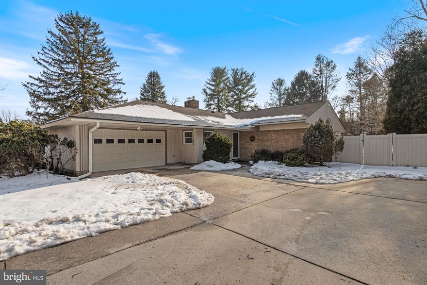 You will want for nothing in this wonderful mid-century ranch home located on a large, sunny and level ¾ acre lot. The entire rear and side yards are fully fenced for your 2 or 4 legged family members. There are only 8 houses on this quiet street that is located just minutes from all the shops & restaurants of downtown Media. Significantly expanded over the years, it provides exceptional living within its 2,552 sq. ft. of heated living space. An attached 2-car garage provides ample space for vehicles with a walk-up attic for additional storage. One has access to the 3-season sunroom from the garage & living room. The entry foyer has a large coat closet, an original display shelving unit along with another hidden storage cabinet. The original oak flooring just shines. A wall of tan bricks line the one wall around the wood burning fireplace.  Mahogany wainscoting surrounds the entire living room and a picture window overlooks the fenced yard. Just off the living room is a cozy dedicated home office with floor to ceiling mahogany vertical boards. Pass from the living to the dining rooms, and you’ll notice the built-in wood storage in the brick fireplace. That brick remains exposed in the dining room, with another large bank of windows overlooking the yard. A corner dry bar provides great storage between the dining room and the kitchen. The kitchen was remodeled in 2010 and provides an abundance of cabinetry, tiled flooring and granite counters. The appliances include a 5-burner gas cooktop, dishwasher, wall oven & microwave/convection oven along with a French door refrigerator. On the other end of the kitchen, a large breakfast bar with seating for 4 stools provides direct access to the amazing family room with a vaulted ceiling. With walls of windows facing south and west, this room is flooded with light throughout the afternoon. A double sliding door provides direct access to the large patio outdoors. All four of the bedrooms are located in the rear of the home. A central hallway directs one to the first guest bedroom with two walk-in closets. That bedroom has access to the first full bathroom that retains all of the original vintage pink American Standard fixtures and wall tiles and a corner shower. This bathroom also has access to the hallway. The second guest bedroom overlooks one of the side yards with a large alcove that provides great space for the dresser without taking away from the floor space. The second full bath was completely remodeled in 2010 and provides BOTH a jetted tub and a large walk-in shower. The third bedroom is located towards the end of the hallway and has parquet flooring and a spacious closet. The primary suite occupies the entire rear of the home with windows on three sides. A large walk-in closet is complimented by a secondary smaller closet, and the en-suite bath has another corner shower. There is a full basement under the original portion of the home, and about two thirds of this space is finished. Separated into two distinct areas, the first section provides great space for another sitting area with built-in bookshelves along with multiple closets for storage. The second are is large enough to have a full-sized pool or ping-pong table (as the current owners have) and also has the laundry area tucked into one corner. The mechanical room is tucked up next to the chimney in it own space. Under the living room, home office and foyer is the remainder of the basement that, while unfinished, provides additional space for storage or even a home gym area. There are two additional cedar storage closets tucked into the far corner of this space. A new fence was installed in 2023 that encompasses the entire rear & both side yards. Two large storage sheds (one is new) are tucked into the rear corner, so there’s no need to take up garage space for your yard & gardening equipment. The garage is wired for an EV charger & has solar panels that are owned (not leased!) that significantly reduce the PECO costs.