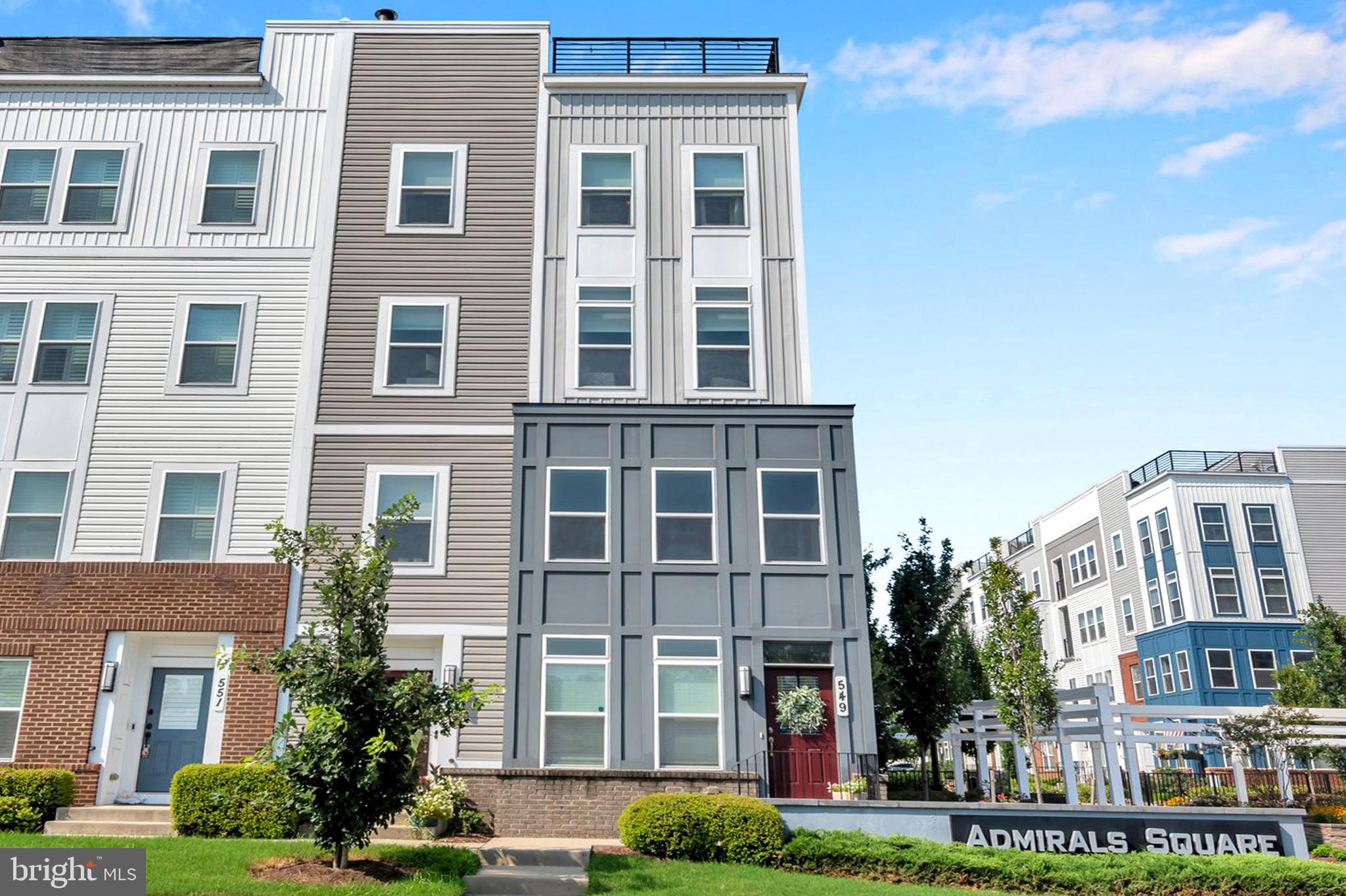 COSMOPOLITAN ANNAPOLIS TOWNHOME BOASTING SKYLINE ROOFTOP DECK! ADMIRALS SQUARE DUAL ASPECT CORNER UNIT offering 2 levels of living with upscale detailing and finishes! 9-Foot ceilings, terrace-like walls of windows, a turnkey urban neutral palette, brick accent walls, and upgraded flooring to enhance any décor. The entry staircase will take you into an open concept Dining area and chef’s choice restaurant-inspired dining bar Kitchen showcasing sleek quartz & stainless steel surfaces. Adjoining the kitchen is a glass-encased living room with a gas fireplace to further enhance ambiance. Upstairs you’ll find a Generous Primary Bedroom Suite with 2-sided walk-in closet w/organizers & luxe spa Bath! The upper level also has two Additional bright ‘n’ airy Bedrooms (flexible use spaces) and a Full Bath with a double vanity. Stairs ascend to a PANORAMIC ROOFTOP VIEW DECK for alfresco dining and entertaining beneath sun & stars! Extended, rear access parking pad & 1-car garage. Minutes to Downtown City Dock harbor, the USNA, Westfield/Towne Centre Malls, eclectic restaurants & crab cake eateries, marinas/boating, and commuter RTs 50/97/2. NYC SOPHISTICATION IN TANDEM WITH RELAXED BAY LIVING!