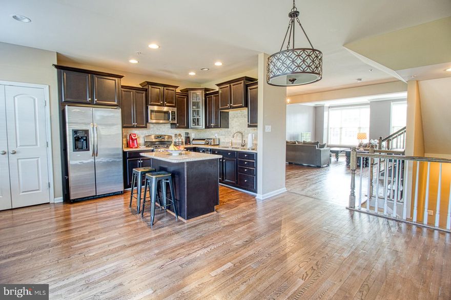 PRICE REDUCED.  Gorgeous 3 story garage town home with 3 fully finished levels in Millstone Village.  2,300 sq.ft. of living space.   Main level features sunny, open floor plan with half bath that is ideal for entertaining guests.  Gourmet eat-in kitchen with granite counter tops, new back splash, kitchen island, stainless steel appliances, newly finished hardwood floors, and entry to your private deck.  Upstairs is a spacious master suite with walk-in closet and luxury bath, which includes soaking tub/separate shower.  Also included upstairs are two additional bedrooms that share a hall bath.  Finished walk-out entry level with family room, half bath, and garage access.  Rear fence, deck, and patio backing to open common area for a private setting.  Fresh landscaping.  Conveniently located close to Ft. Meade, NASA, BWI, Arundel Mills, Columbia, Baltimore, and Washington, D.C..  Welcome home!