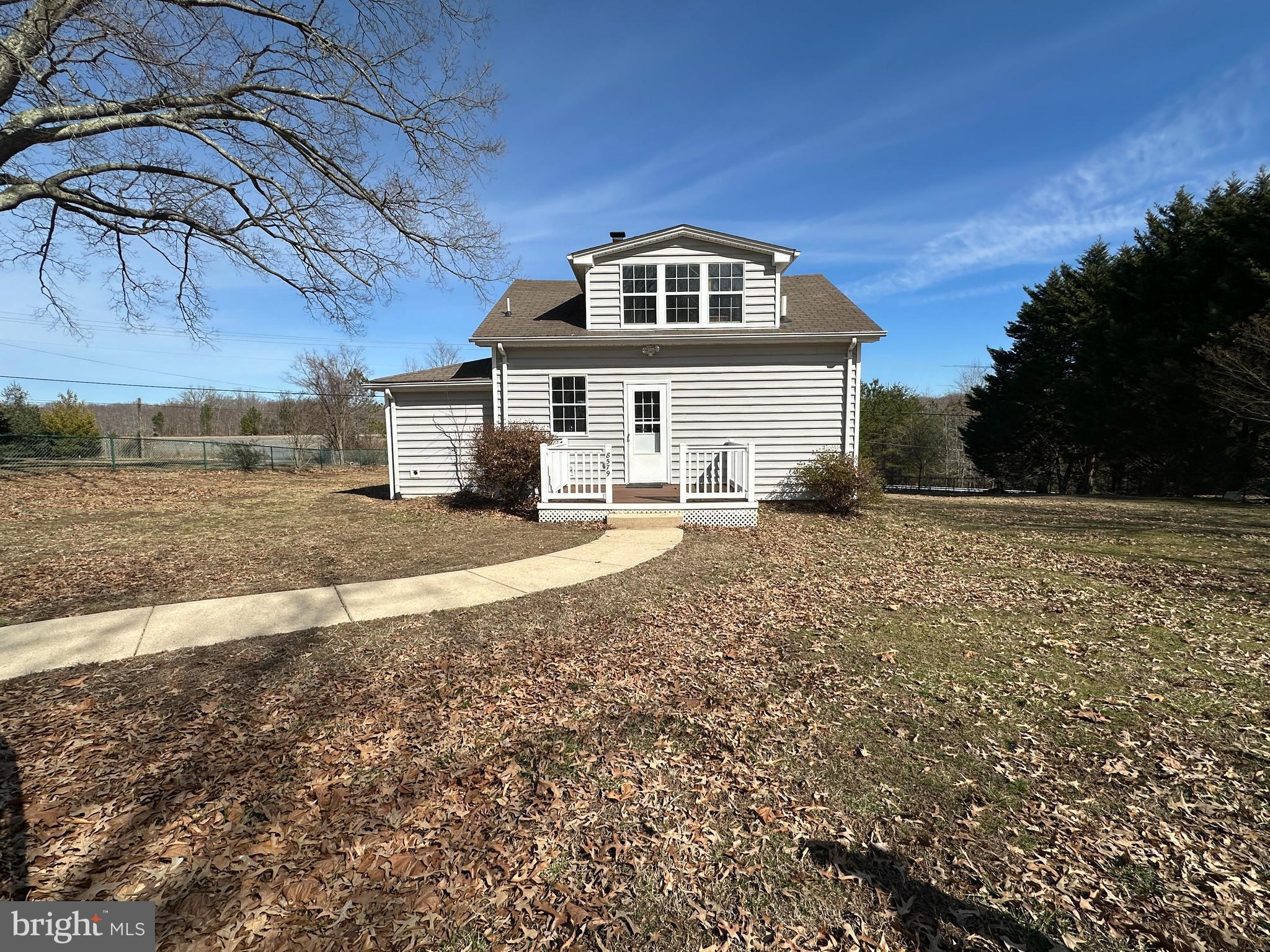BACK ON THE MARKET. PRICE REDUCED! Welcome to this charming cape cod showcasing a generous, fully fenced half-acre lot just perfect for pet owners or children. This home offers a blend of comfort and convenience boasting two cozy bedrooms (with potential to convert it back to a three bedroom) and one and a half bathrooms. The property has been completely refreshed with new SS appliances, new carpet, new luxurious vinyl floors, new water heater, and fresh paint throughout. A fully enclosed front porch offers peaceful tranquility and the brand new maintenance free rear trex deck brings quiet evenings enjoying the natural surroundings. Additional amenities include a large storage shed, a practical circular driveway, and a peaceful backdrop of trees providing privacy and serenity. Shed is AS-IS.