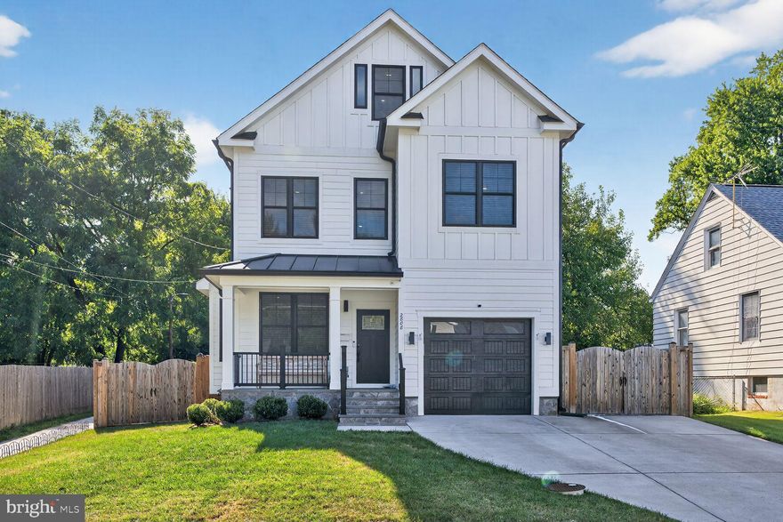 Built in 2022! Gorgeous contemporary farmhouse with over 3700+ sq ft of thoughtfully designed living space in iconic Greenway Downs! Situated on a quiet street, this three level home with a charming front porch features a total of 5 bedrooms and 4.5 baths. An expansive main level with 10' ceilings is beautifully configured for family living with an open dining room and spacious family room with coffered ceiling and gas fireplace . From the family room you can step right out to a fully fenced back yard. A large gourmet kitchen with smart fridge is just steps from a custom mudroom with loads of storage and two tone cabinetry. An additional office/dining room and powder room on the main level provides ultimate flexibility. The first upper level with 9' foot ceilings offers a spa-like primary suite complete with engineered wide-width wood floors, 2 walk-in closets, ensuite bath with soaking tub and generously proportioned tile shower. A second en-suite bedroom is down the hall while two more bedrooms on this level share a hall bath. A conveniently located laundry room completes this level. The second upper level features a rec room and a fifth bedroom with hall bath and also has 9' Wide-width LVP floors are throughout the 2nd floor. Moments to Falls Church City’s restaurants, shops and renowned Farmer’s Market. Conveniently located minutes to Metro, Route 50, 66, 495 and the Mosaic District.