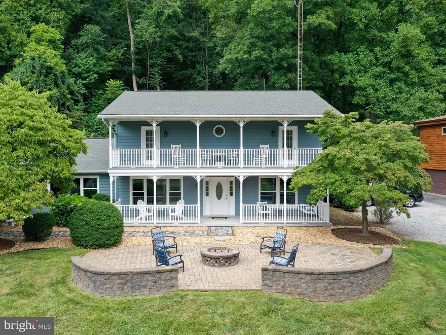 Amazing opportunity to own this unique and spacious home right on the Potomac River. Beautifully updated, this 3 bedroom, 3 bath home has all-season river views on the waterfront with a brick patio for relaxing and a private floating dock for your water toys! Rare, deep-water access for fishing, boats, jet skis and water sports. The gorgeous two-level front porches and outdoor patio with firepit provide inviting outdoor living and entertaining space. Entering the home from the front, the artisanship is clear in the architectural details and the orientation towards the river views. Walk into the sunny foyer with gorgeous hardwood floors that continue into the sitting room and formal dining room. Off the dining room is the large eat-in kitchen with a new stainless-steel dishwasher and refrigerator, double-ovens, a walk-in pantry, and generous island. Open to the kitchen is a vaulted family room with LVP flooring, exposed beams, and a stone fireplace with enameled wood stove. A full bath and separate laundry room and office space, with new laundry machines, are off the kitchen on the opposite side. Beyond them is a bonus room that could house any variety of additional activities, or be altered for a ground-level, master suite. This room is on a separate climate control system with a new mini split. Through this cavernous space are the two long garage bays and an electric car charger. Upstairs, there are three bright, generous-sized bedrooms, two of which open directly onto the upstairs veranda. The master bedroom’s en suite bathroom has a claw footed bathtub and a unique high tank toilet with gold-plated hardware. Come live the dream all year round: an investment opportunity or home-away-from-home! Just minutes to the Appalachian Trail, the C&O Canal, and within easy access to commuter routes to Maryland, Virginia, and the DC metropolitan area!
