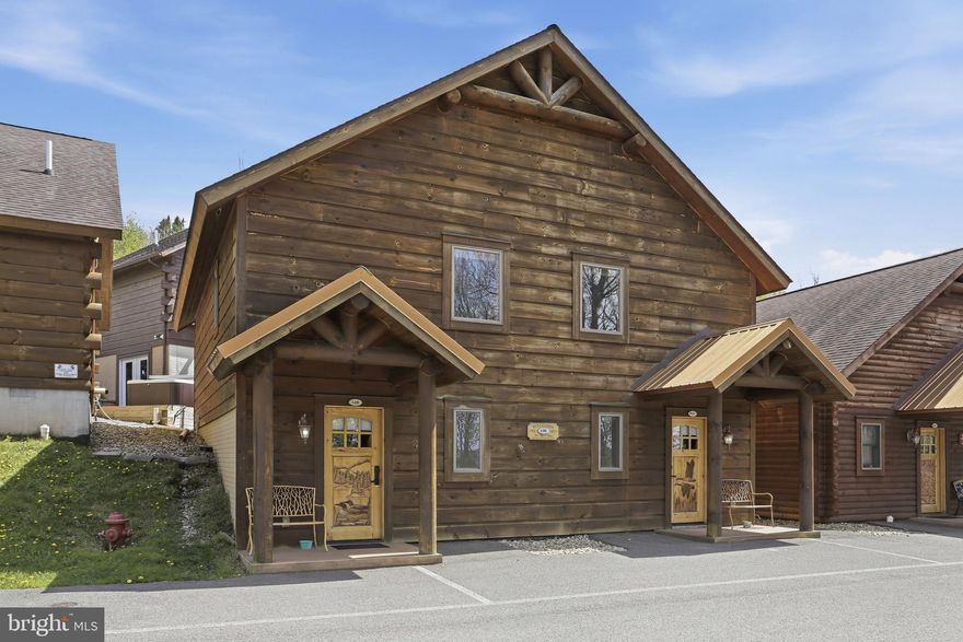Cabin #46 at The Lodges of Sunset Village is a detached home offering two "lock off" units with a shared door between the units with 1472 square feet. Each side offers an efficiency-style layout on the main floor with two beds and a full bath, and a 2nd level with a separate bedroom and full bath. 

Rich in mountain character and charm, this log cabin features uniquely carved wood doors, beautiful beamed ceilings, warm wood walls, and inviting spaces that create an authentic lake and mountain retreat feel. Additional features include lake views, ski slope views, expansive decks and patios, upgraded finishes, open concept living, stacked stone gas fireplace, and open concept living.

Enjoy incredible views of Deep Creek Lake and Wisp, along with front row seats for seasonal beauty and memorable moments, including views of the annual July 4th fireworks. This property has a proven rental history, generating an average of  $66,320  in annual gross rental income creating an exciting opportunity for buyers seeking both personal enjoyment and investment potential.

Experience one of Deep Creek Lake’s newest ownership opportunities at The Lodges at Sunset Village. For the first time ever, fully furnished lake area cabins are being offered for individual ownership in a breathtaking community featuring incredible lake and Wisp ski slope views. Community amenities include lake access with 10 shared dock slips and an impressive 1,320 square foot waterfront dock area perfect for fishing, swimming, launching kayaks, relaxing by the water, and enjoying summer fun at the lake. Residents and guests also enjoy a lakeside gazebo, playground, fire pit, gathering areas, pet-friendly accommodations, abundant parking, and on-site professional management.

The monthly condo fee provides exceptional convenience, including most utilities, snow removal, trash service, and yard maintenance, for a low-maintenance ownership experience. Whether you're searching for a vacation retreat, income-producing investment, or both, The Lodges at Sunset Village offers a rare opportunity to own at Deep Creek Lake. Stop by our on-site Sales Center at The Lodges Gatehouse during open hours to learn more, explore ownership opportunities, and get your questions answered: Thursdays 2:00–6:00 PM, Fridays 1:00–5:00 PM, Saturdays 10:00 AM–5:00 PM, and Sundays 10:00 AM–2:00 PM or call today for details and your private showing!