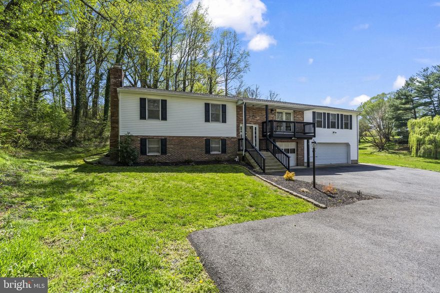 Welcome to this expansive 3BR, 3BA split-foyer in Chesapeake Beach! The light-filled upper level boasts a seamless flow between the living area and an updated kitchen with granite countertops and stainless steel appliances. Step into the stunning sunroom off the kitchen—your private sanctuary for morning coffee with views of the fully fenced-in backyard that backs to trees! The finished lower level features a classic brick fireplace with a pellet stove insert, a bar area, a full bathroom, and additional space for a hobby room, access to the garages, etc!  Great location! Minutes to the Chesapeake Beach Resort & Spa, marinas, boardwalk, Bayfront Park, and local dining. Enjoy the best of the beaches, shopping, and waterfront lifestyle right at your doorstep!
