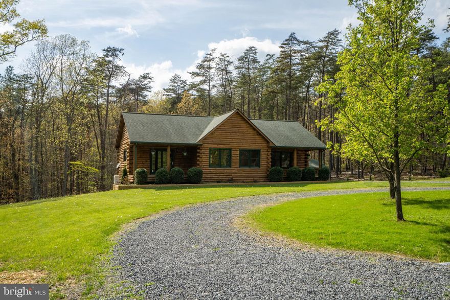 Log Cabin In The Woods, Located 2 Miles From Rt 50 West, 13 Miles From Winchester And 1 Mile From Capon Bridge!  Spectacular Log Home, Gore VA! 6.24 Acres, Rural And Mostly Private.  The Home Sits In The Back Of This This Quaint Subdivision. On The Main Level, There Are 3 Full Bedrooms And 2 Baths.  The Full Kitchen Sits In The Back Of The Home With A View Of The Back Yard And Wooded Areas!. The Living Room and Kitchen Are Combined. All Of The Appliances Are New! This Home Was Just Freshly Painted On The Inside.  In Addition, All Of The Hardwood Flooring On The Main Level, Has Been Refinished! The Primary Bedroom Has A Primary Bath, Primary Closet and Exit Onto The Cozy Front Porch!  The Basement Is Fully Finished, With A Recreation Room, 1 Additional Bedroom, An Office Or Can Be Used As 5th Bedroom Full Bathroom, Storage Room And Utility Room! The Exterior Of The Log Home Has Been Completely Restained With A Longlasting Treated Stain! The Outbuilding Is An Open Large Space, For Workshop And Storage. 
The Home Has HVAC Electric, Which Is Being Serviced. The Basement Has Mini Splits For Heat And Cooling. Septic System Has Been Pumped and Inspected, WDI Every Quarter, Water Test Results Uploaded.Several Internet Options- FoxWireless, StarLink, Wave2net. Road maintained by HOA. Road Is Not Paved.