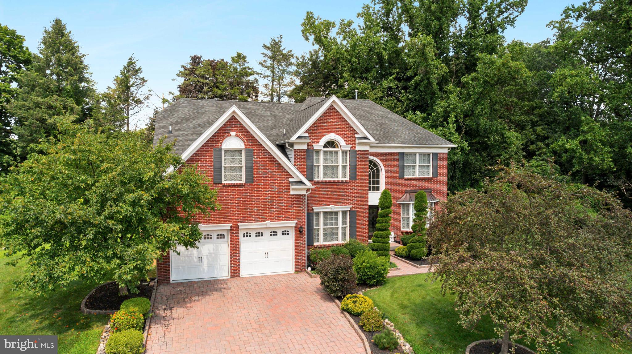 Welcome to this beautifully appointed residence tucked away in the highly coveted community of The Reserve at Southampton. This stately four-bedroom, three-and-a-half-bath home offers refined comfort, exceptional space, and elegant architectural details throughout, all designed for today’s modern lifestyle.
A grand entry begins at the elegant double front doors, where you’re greeted by a sweeping staircase featuring custom wrought iron balusters that make a stunning first impression. Rich hardwood flooring flows throughout the main level, setting a warm and polished tone. To your left, French doors open to a private home office, perfect for remote work or a quiet study. To the right, an inviting formal living room boasts detailed millwork, including crown molding and chair rail, which continues into the adjacent formal dining room.
At the heart of the home, the designer kitchen is a culinary enthusiast’s dream. Anchored by a large center island and generous dining area, this space features sleek granite countertops, an upgraded tile backsplash, and rich cabinetry with detailed molding. A full suite of stainless steel appliances, including a wall oven, microwave, electric cooktop with modern vent hood, and dishwasher, add both style and function. The sunny morning room with sliding glass doors opens directly to the outdoor patio, making it the perfect casual gathering spot for meals and conversation.
Just beyond the kitchen, the impressive two-story family room features a wall of oversized windows that flood the space with natural light, as well as a second staircase to the upper level for added convenience. An electric fireplace adds ambiance and charm, creating a cozy space for everyday living. Also on this level, a stylish powder room and a laundry room complete the layout.
Step outside to enjoy your own private outdoor escape. A spacious paver patio extends your entertaining space and is ideal for dining al fresco or relaxing under the stars.
Upstairs, the luxurious primary suite is a true sanctuary. Double doors lead into a light-filled bedroom with soaring ceilings, a sitting area, and an expansive walk-in closet. The spa-inspired en-suite bath offers dual granite-topped vanities, an oversized shower, a deep soaking tub, and a bidet, blending function with indulgent comfort.
Three additional bedrooms provide ample space for family or guests, each with generous closets and access to a well-appointed hall bath with dual sinks.
The fully finished basement is a showstopper, offering endless possibilities for entertaining, relaxing, or working from home. A custom-built wet bar with granite counters, cabinetry, and a wine fridge elevates the space, while a separate glass-enclosed room currently functions as a second office. A full bathroom with floor-to-ceiling tile, modern fixtures, and a luxurious shower adds both style and flexibility. Plenty of storage space ensures there’s room for everything.
With a two-car garage, extended driveway parking, and beautifully maintained throughout, this exceptional home is move-in ready and truly one of a kind. Don’t miss the chance to experience refined suburban living at its best.
