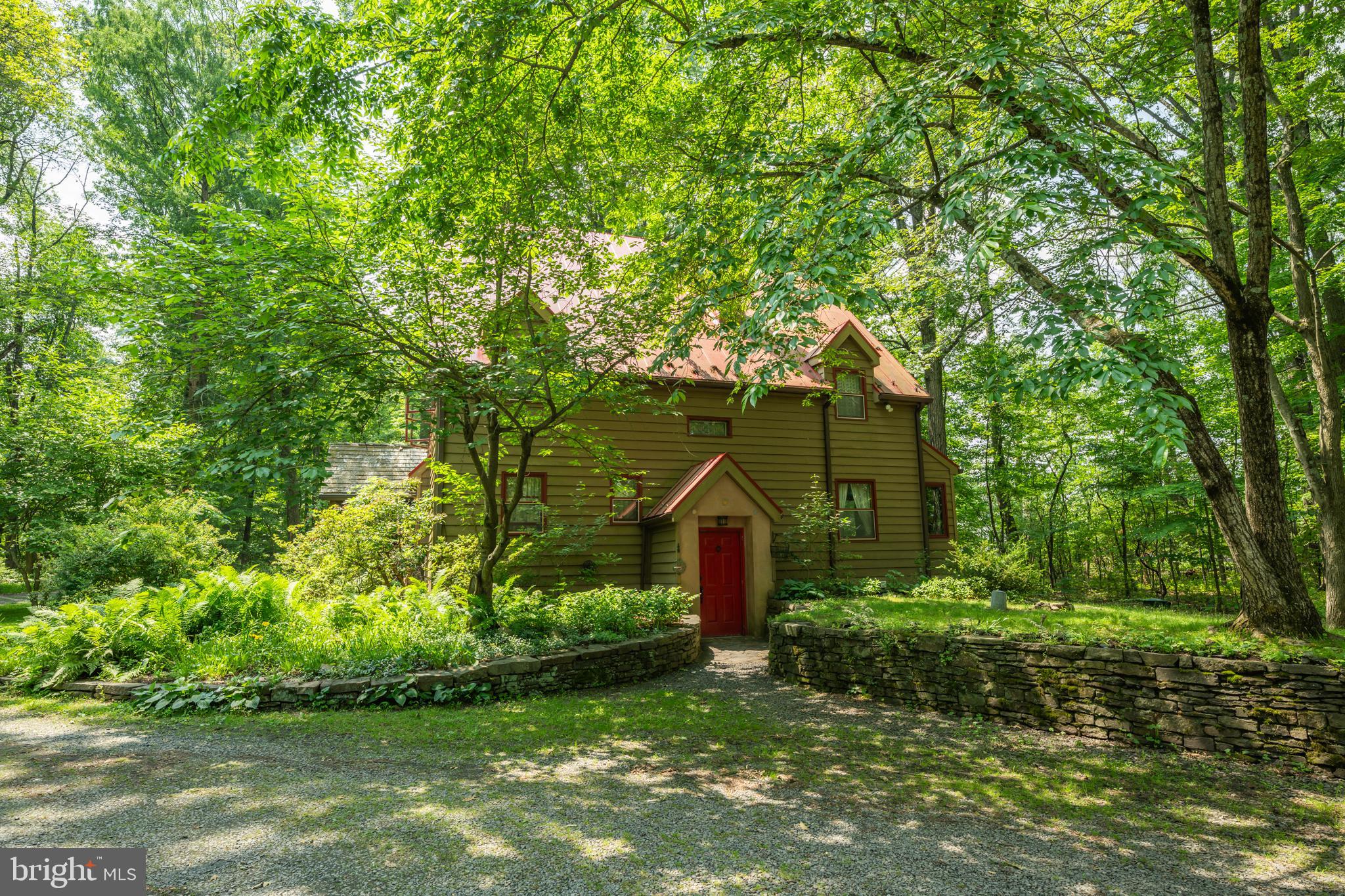 Tucked away at the end of a long, graceful driveway in one of Bucks Counties greatly desired areas , this enchanting property feels like neverland. Perfectly set on 10 breathtaking acres, this home is surrounded by natural beauty, a mix of mature woodlands as well as open meadows, boundless gardens and perennials that offer a sense of timeless tranquility. Here, the views feel like a painting with every season offering its own charm. Though it feels worlds away from the bustle, your just minutes from the heart of Doylestown Boro, where you will find fine dining, boutique shopping, entertainment and all of the conveniences you could wish for. This home is a rare combination of a serene retreat with an unbeatable location, a place where peace ,beauty and convenience live in perfect harmony. Designed by its owner with both beauty and sustainability in mind, this passive solar home welcomes you with light-filled spaces that feel as peaceful as they are energy-efficient. A spectacular sunroom, expansive in scale and wrapped in walls of glass, invites the beauty of the season inside. Bathed in natural light from dawn to dusk, this addition offers endless possibilities from morning coffee among the treetops to evening gatherings under the canopy of stars. It is a space that feels both grand and intimate, perfectly complementing the homes open, airy design. The stunning kitchen design offers a blend of artistry and function where every detail invites you to linger. The nice-sized bedrooms provide comfort and livability, while the atmosphere remains airy and inviting. Hand selected tiles throughout the home add texture, color and a soulful, one-of -a-kind character, while the homes thoughtful design creates a calming, meditative atmosphere allowing to connect with nature inside and out. Some outside added features include a whole house generator, rich soil built through decades of organic composting for large vegetable and flower gardens , a generous harvest each year from productive berry bushes. Outside areas to sit , relax and just listen to the birds sing. The spacious two car detached garage not only offers room for vehicles but also has the potential to create a workshop or hobby space. Opportunities like this, a property with acreage in a highly desirable area are far and few between. Schedule your private showing and experience the beauty this exceptional dream property has to offer.
