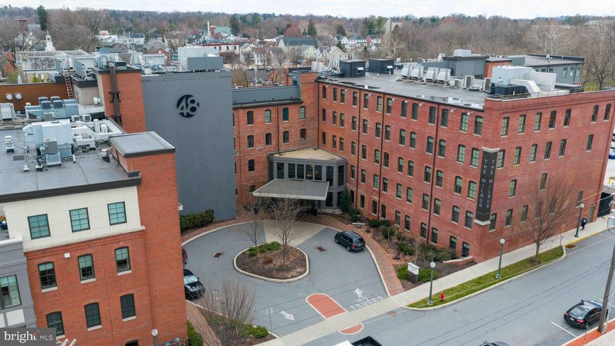 Welcome to 48 on the Park, where historic, industrial architecture meets modern luxury. As part of the Wilbur Hotel, which won the Connie award for Best Hilton Boutique Hotel in the world in 2024, condominium owners are treated to a wide variety of amenities including concierge, valet parking, cleaning services, laundry pick up and delivery, package management, event planning, fitness center and pet sitting along with the amazing Khol Chophouse and Cavolo! Italian for all day, on-site dining!
Enjoy the exclusive condo owners rooftop lounge for grilling, happy hours with your condo neighbors or just take in the view. 
This stunningly designed two bedroom, two bath corner condo offers sweeping views of Lititz Spring Creek and Park and downtown Lititz. High-end finishes include hardwood flooring, custom cabinetry, honed granite countertops, soaring ceilings, and original Wilbur chocolate factory exposed brick and beams.
All located in charming, historic Lititz, one of America’s Coolest small towns!