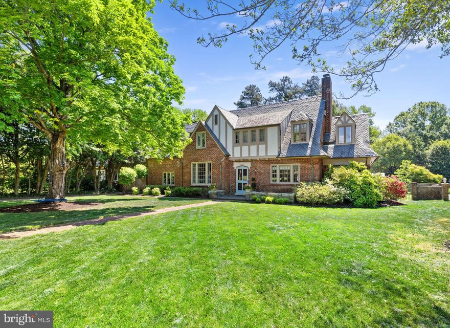 Located in desirable Hampton Gardens, this classic Tudor residence blends timeless architecture with thoughtful updates & beautifully designed living spaces with exceptional indoor-outdoor flow. Enter through the arched oak front door into a hardwood foyer flanked by formal living & dining rooms. The living room features exposed beamed ceilings, a stone natural gas fireplace, & access to a bright & airy sunroom with an adjoining custom full bath completed in March 2026, which offers flexibility for a potential first-floor primary suite or guest retreat. The kitchen flows seamlessly into the spacious family room with built-in bookshelves & is complemented by a large Butler’s pantry, creating exceptional functionality for entertaining. The main living spaces offer the perfect balance of classic character & modern functionality. Upstairs, the expansive primary suite features a large dressing room, a fully renovated spa-like bath completed in 2023 with heated tile floors, a soaking tub, a custom tiled shower, & an office/workout room. Three large bedrooms, two full baths, a laundry area, & a walk-up attic for additional storage complete the 2nd floor. Outside, multiple doors from the foyer, kitchen, & sunroom lead to a gorgeous rear terrace, creating seamless indoor-outdoor flow. The backyard offers mature landscaping, flowering plants, towering trees, & open lawn areas with room for recreation or a future pool. Additional features include a detached two-car garage with automatic doors, basement storage, & secured storage space in the garage. Additional updates include a new first-floor HVAC heat pump system with a built-in humidifier, 80-gallon gas water heater, exterior paint, driveway drainage improvements, & a whole-house Generac natural gas generator installed in December 2025. This classic Richmond Tudor offers the perfect balance of character and comfort in one of the city’s most desirable neighborhoods with walkability to all that Libbie & Grove have to offer!