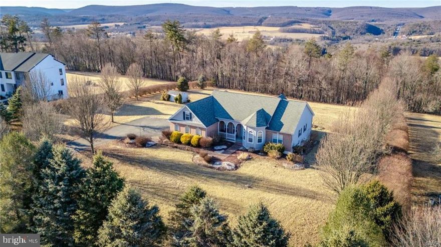 Exciting opportunity to own this beautiful 2000+ square foot ranch home with wonderful curb appeal.   One level living at its finest starts with a quality made custom kitchen,  countertops and breakfast bar.  Separate eating area with patio doors leading to a spacious elevated backyard deck overlooking views of the beautiful Pennsylvania mountains.  Enjoy a large open floor plan that creates a warm inviting atmosphere in the main family room with vaulted ceilings and a propane fireplace.  Secondary family room with beautiful bright windows in addition to an office, den or study.  3 nice sized bedrooms each with their own Ensuite and walk in closet.  Large laundry area and storage closet in addition to a half bath for your guests finishes off the main floor.  Full walk out basement with workshop, huge amount of storage and plenty of room for additional living space if you desire.  Oversized 2 car attached garage is a bonus!  Outdoors offer beautiful covered front porch, elevated rear deck, macadam driveway and over 2 acres of land.  Come see for yourself how great this home is and call for your private showing today.