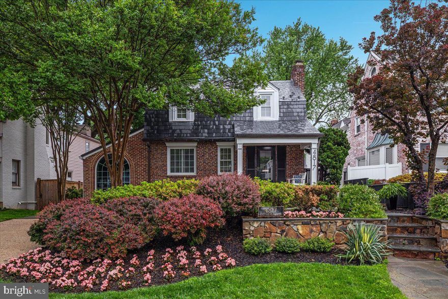 Rarely available in Chevy Chase West, this meticulously restored 4-bedroom, 3.5-bath Dutch Colonial has been thoughtfully expanded with two above-grade additions that enhance both space and functionality while preserving the home’s timeless architectural character. Blending classic charm with modern luxury, this exceptional residence offers elegant living in a walkable, tree-lined neighborhood just minutes to downtown Bethesda and Friendship Heights, with convenient access to Red Line Metro stations nearby.

From the moment you arrive, the inviting front porch and lush, professionally designed gardens—crafted by one of Washington, D.C.’s leading landscape architects—create a stunning first impression. The fenced backyard is a private oasis featuring terraced dining areas, stone walkways, perennial gardens, and mature trees, offering both tranquility and natural beauty.

Step inside to a gracious foyer that balances elegance and functionality. Highlights include custom millwork, arched openings, oak hardwood floors, and a masonry fireplace with emerald pearl granite detailing. The formal living and dining rooms are ideal for entertaining, enhanced by French doors, plantation shutters, and designer lighting.

At the heart of the home is the gourmet kitchen custom-designed by Tunis Kitchens. With vaulted ceilings, black patina cabinetry, and marble and Jerusalem limestone floors with a mosaic medallion, this kitchen is a showpiece of craftsmanship. Top-of-the-line Thermador and Sub-Zero appliances, along with a new KitchenAid dishwasher, make it a true chef’s dream. The sunlit breakfast room with custom cabinetry, wet bar, and wine fridge provides the perfect setting for casual dining and everyday gatherings.

The spacious media and gathering room is equally impressive, featuring a wood-burning fireplace with Verde marble surround and a built-in home theater system complete with retractable screen, projector, and Dolby surround sound—ideal for entertaining or relaxing evenings at home.

Upstairs, the primary suite serves as a luxurious retreat, featuring cathedral ceilings, exposed beams, a wood-burning fireplace, and dual walk-in closets with European organizers. French doors open to a Romeo and Juliet balcony overlooking one of the area’s oldest trees. The spa-inspired primary bathroom features a soaking tub, frameless glass shower, Blue Pearl granite countertops, designer fixtures, and skylights that fill the space with natural light.

Three additional bedrooms offer comfort and character, featuring oak floors, plantation shutters, and architectural details such as dormer windows and vaulted ceilings.
The lower level provides a versatile recreation room, full bath, laundry area with front-loading washer and dryer, and a secure storage room.

Parking is effortless with an extra-wide driveway and ample street parking.
Located in the heart of Chevy Chase West, this home offers a rare balance of peaceful residential living and exceptional urban accessibility. Residents enjoy close proximity to Norwood Park, Rock Creek Park, neighborhood parks and trails, and the Capital Crescent Trail, making outdoor recreation and scenic green space part of everyday life.

The neighborhood is also close to some of the region’s most prestigious country clubs, including Chevy Chase Club and Congressional Country Club, along with premier shopping, dining, and cultural venues in nearby Bethesda and Friendship Heights.

The home is located within the boundaries of top-rated Montgomery County schools, including some of the most sought-after Chevy Chase elementary and high schools.

With its thoughtful architectural additions, premium finishes, timeless design, and extraordinary craftsmanship, this residence offers luxury living in one of Maryland’s most coveted and established neighborhoods. Homes of this character, scale, and location in Chevy Chase West are seldom available.