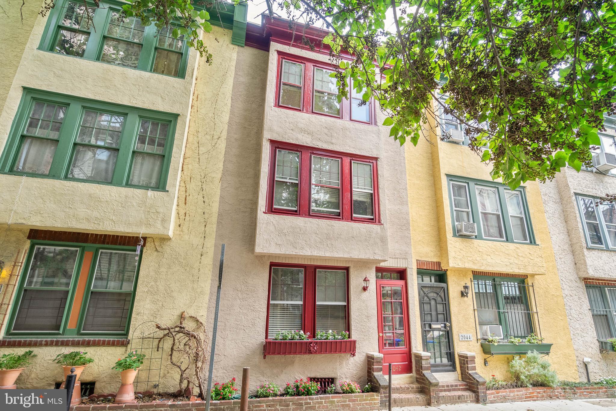 Steps away from sprawling Rittenhouse Square Park on a hidden, low traffic, dead-end, cobblestone block, you'll find 2042 Latimer St. This updated 3-story home offers 2 bedrooms, 2 full bathrooms, a private outdoor space, and lots of unique character. Lush trees shade the picturesque front facade, brightened red accents and lively planters. Inside, the spacious, sunlit living room is framed by inlaid hardwood floors and tall ceilings. A glass block wall illuminates the separate dining area, where tile floors extend into a kitchen featuring shaker cabinetry, granite counters, an exposed brick backsplash, and stainless steel appliances, including a dishwasher and Cafe Microwave . Up on the carpeted second level, there's a large bedroom boasting great natural light from three tall windows, an exposed brick wall, and a generous closet. The attached full bathroom has a glass-enclosed shower, and a door at the rear opens to a secluded terrace that's the perfect spot to relax with a morning cup of coffee or evening glass of wine. The second bedroom on the top floor has hardwoods, more bright windows, and its own full bathroom. Completing the home is a clean, dry basement that has the laundry and extra storage space. Utilities include central a/c, gas hot water, and radiator heat. One of 2042 Latimer St's highlights is surely its sought-after Rittenhouse Square location, earning a near-perfect Walk Score of 98! The city's best restaurants, shopping, and entertainment line the surrounding streets. Plus, there's easy access to public transit, the extensive Schuylkill River Trail, I-76, and The University of Penn. Schedule your tour today!