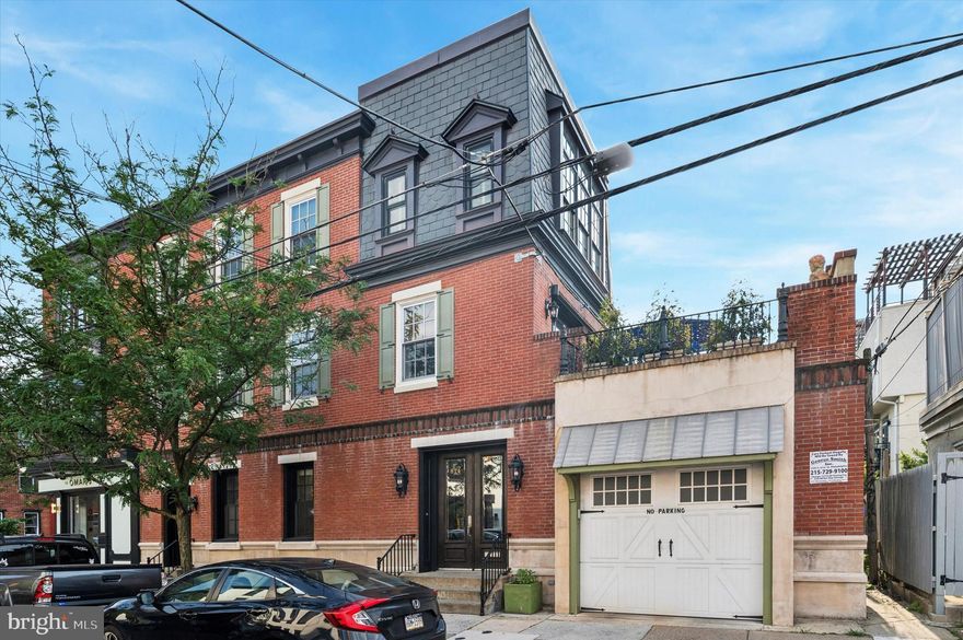 Unparalleled 3 Story Townhome with Semi-Private Professional Office on a Beautiful Corner! Enter through 8 ft doors into the mahogany-paneled vestibule. A private professional office and powder room is on the ground floor. Proceed to the private quarters which features direct access to the large garage. Up the stairs to a large living room with a wall of French doors overlooking a spacious fiberglass terrace with fantastic views of the city skyline. Back inside, an ornate archway leads to the sunny kitchen, which features stainless countertops, 36" Italian range, 2 sinks, Bosch dishwasher and a remote exhaust system. A beautiful granite island provide additional cabinetry and seating.  In the adjoining dining room, a large bay window overlooks a landmark Furness-designed church, and an antique cut crystal chandelier casts a warm glow. This main living floor is perfect for entertaining. The third floor features a central sky-lit hallway, off of which is a comfortable guest room, another office/bedroom, and a full-sized laundry & storage closet. Inside the primary suite is a built-in dressing area which leads to the primary bath which includes a large, marble topped double vanity, shower for two, and is tiled floor to ceiling with large slabs of Carrera marble. The sleeping area is a stunner with 12' ceilings, 20" crown molding and huge windows overlooking the complete Philadelphia skyline. Just a short walk to Rittenhouse and the many shops, restaurants and gyms of South Street West and Washington Ave.   Convenient to U Penn, Drexel and interstate 76. Located in the Chester A. Arthur elementary school catchment.