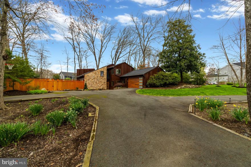 This house is a Vibe - Your opportunity to own the coolest house in the neighborhood! This exceptional contemporary home sits far back from the street, on over ½ an acre, in Fairfax’s sought-after Mantua community. Open floor plan with 3 bedrooms and 2 ½ baths and over 2,600 total square feet. The bright, airy and open main level has that wow factor, with oversized windows, newly refinished hardwoods throughout, skylights and a dramatic pitched ceiling, giving the space tons of natural light! The eat-in kitchen has a large center island, with seating for 4, sandstone counters, soft-close cabinets and high-end stainless appliances. Cozy family room stone fireplace and built-in bookshelves, and open living and dining with direct access to the backyard through Pella sliding glass doors.The primary ensuite bedroom, with dramatic ceiling height, a great tree-lined view and direct access to the back patio and a custom-built walk-in closet. The primary bath has separate vanities and an oversized walk-in shower. Two spacious bedrooms upstairs share a Jack-and-Jill bathroom.  2-car garage has been converted to offer extra living space, with an upgraded, insulated garage door, but can easily remain as a garage. Fully fenced and newly landscaped, private tree-lined back with heated pool, natural stone waterfall fountain and several patio levels spacious enough to create separate grilling, eating, and lounging areas. Notable features: Wood-burning fireplace in family room, Pella windows, custom closets, recessed lighting, solid wood doors, solar pool cover. Enjoy several parks around Mantua, offering trails, sports courts and playgrounds, as well as the Mantua Hills Swim and Tennis Club. Less than a 2-minute drive is the Mosaic District, with dozens of restaurants, cafes, exercise studios, a movie theater and Target. Multiple commuting routes are available, access to Rt 50, I-66, I-495, and less than 10 minutes to two Metro stations - Vienna and Dunn Loring.