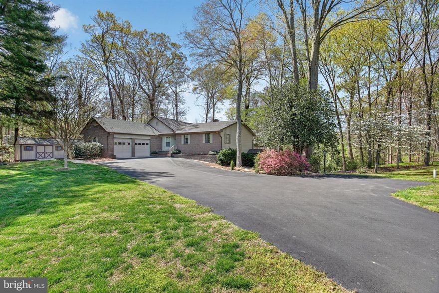 Location, location, location!  Beautifully maintained 3 Bedroom, 2.5 Bath Brick Rambler with basement and 2-car garage on 3.87 private acres.  Be surrounded by mature landscaping, Mountain Laurels and trees with lots of private outdoor spaces to enjoy your property. The gourmet Kitchen is for "cooking lovers" and a central spot for entertaining! Bright vaulted ceilings with skylights, Corian counters, huge center island with extra sink, breakfast bar, lots of unique storage areas in solid maple cabinetry, subzero refrigerator, stainless steel appliances, 6-burner propane stove with double ovens, pantry, and lots more! Breakfast Room has a stand-alone gas fireplace, one of 3 fireplaces in the home, and sliders to walk out to a huge Deck with motorized awning overlooking the private yard.  Dining Room has built-in glass/maple cabinets and granite buffet surface. The unique adjoining office is off the Kitchen with lots of built-in cabinetry. Living Room is bright with vaulted ceilings and another walkout to the Deck.  Check out the gorgeous Hearthstone Woodstove in the Living Room! The enclosed porch/sunroom off the Living Room is cedar lined and a great hangout. The 3 Bedrooms are carpeted and the hall full bathroom has been modified for handicap access (widened doorway, walk-in shower with safety bars). Full-size washer/dryer is on the main level in the Laundry Room with cabinets, counter, sink and shelving. A handicap wheel chair lift is operational in the 2-car garage to ensure easy access to 1-level living at its best!  The finished basement has a rec room with a 3rd fireplace (propane), a walk out to the side yard, a utility/furnace room and an extra storage room. The double-shed is used as a workshop (has an A/C unit) and storage area and also has a built-in firewood storage section. The entire property has invisible fencing for pet owners! There are brick walkways and thoughtfully located sidewalks.  It’s hard to list everything, so owners are putting together a comprehensive list of features, upgrades and maintenance items over the 40 years they have enjoyed this special spot in northern Calvert County.  No HOA.  Views on the property have been the same for 40 years, since the land behind the property is protected wetlands and everything in front of property is in agricultural preservation. Feel like you’re in the country, yet you’re close to shopping and commuting north to DC area! Be sure to watch the walk-thru video!