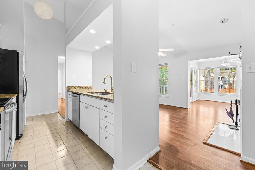 This westerly-facing penthouse/top floor unit features a soaring vaulted ceiling over the living room & kitchen creating sun-filled, cheerful living spaces. The kitchen boasts stainless steel appliances, granite counters and breakfast bar and opens to the living room that has a handsome wood burning fireplace with marble surround as the focal point.  The sunroom offers versatile uses (separate dining room? yoga space? art studio or office?)  and opens out to the deck.  Down the hall is the laundry room and two well-proportioned bedrooms, including a primary suite with walk-in closet and ensuite bath.  Just across the street from Quarry Lake shopping, restaurants and services and conveniently located just minutes to major commuting routes. FHA financing is not accepted in the community.