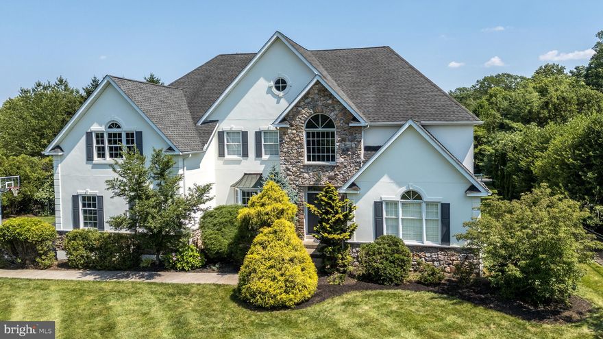 This pretty 5-bedroom, 3 full and 2 half-bath Colonial offers over 6200 of living space in an ideal blend of space, flow, and comfort—with seamless access to everything you love in a community setting.
Step inside to find generously sized rooms throughout, with 9-foot ceilings on the main level (10-foot ceilings in the family room) and rich hardwood flooring in the foyer, living room, dining room, and office. The living room and office feature elegant plantation shutters, while the dining room is accented by a charming bay window.
The spacious kitchen is designed for both everyday living and entertaining, complete with a center island, cooktop, double ovens, walk-in pantry, and a sunlit breakfast area. The kitchen opens into a large family room with floor-to-ceiling stone fireplace, and a wet bar—perfect for gatherings. Just off the kitchen is a bright, inviting sunroom with peaceful views of the backyard.
Convenience meets function in the expansive mudroom, which includes two closets, laundry area, and access to the back entry and attached garage. The main level also features two staircases (formal and family) and two powder rooms.
Upstairs, you'll find five bedrooms including an impressive primary suite with a sitting area, walk-in closet, and en-suite bath. Four additional bedrooms share Jack-and-Jill bathrooms, and there's a central linen closet for added storage. A staircase from this level leads to an unfinished loft offering 772 square feet of potential living space.
The fully finished basement includes a large recreation room, a bonus room, and a dedicated workshop, ideal for hobbies, play, or entertaining.
Outside, the fenced backyard backs to beautifully preserved open space, walking trails, and a scenic horse farm—offering privacy and natural beauty year-round. With great schools, parks, shopping and easy access to main thoroughfares this beautiful property is more than a house, it’s a place your family will cherish for years to come.