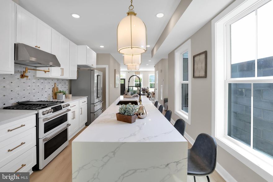 Welcome to this stunning 4-bedroom, 4.5-bath luxury townhome, offering four levels of designer living space with high-end upgrades and custom details throughout. The sun-filled main level features an open concept layout with oversized windows, recessed lighting, wide-plank luxury vinyl flooring, and a grand custom kitchen complete with a massive island, luxury ZLine refrigerator, café series stove with range hood, pot filler, custom cabinetry, and matching dishwasher, alongside a spacious dining area, bright living room, and stylish powder room. The finished lower level provides a versatile rec room, full bathroom, laundry/storage space with a GE Profile all-in-one smart washer/dryer, and walk-up egress. Upstairs, the private primary suite boasts sweeping downtown views, a large walk-in closet, and a spa-inspired bathroom with luxury finishes and a heated bidet, while additional bedrooms offer generous closets and designer touches. Step out to the expansive two-tier rooftop deck with Trex decking and vinyl railings to enjoy breathtaking panoramic city views, perfect for entertaining or relaxing. Additional highlights include a new zoned HVAC system, new hot water tank, multiple walk-in closets, an electric fireplace, and luxury bathrooms throughout. Ideally located steps from the West Baltimore MARC Station—currently undergoing transformative updates to enhance access and connectivity to Washington, D.C. and New York—this home combines modern style, comfort, and investment potential, all showcased by its striking blue brick façade and custom windows.
Schedule your private tour today! Tons of buying incentives included—ask how!
*Property qualifies for making to value $10,000 booster grant*