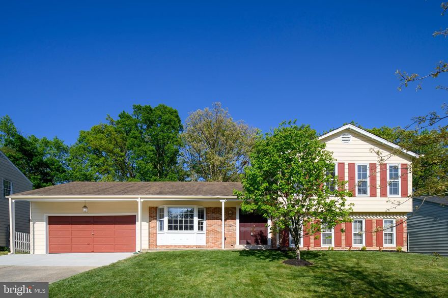 Beautiful home with fresh paint throughout and new carpet on upper level; double door entry leads you to a spacious foyer with new luxury vinyl tile; main level includes living and dining rooms with cherry hardwood floors and  newer slider to backyard; updated kitchen with bay window and table area; lower level consists of huge family room with hardwood, gas fireplace with brick hearth and built-in shelves, 5th bedroom or office, laundry and rough-in for future full bath; upstairs includes large primary bedroom with updated bath, 3 additional bedrooms and updated hall bath.  Sub-lower level is unfinished and perfect for your touches or storage; oversized 2 car garage with built-in storage and insulated attic space above. Extras include 4 ton heat pump, slop sink,  sump pump, and newer HWH.