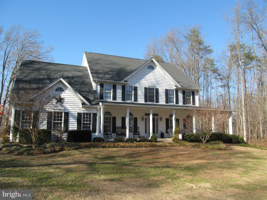 Stunning custom colonial with over 4500 finished sf ft.  Custom moldings, wood floors, granite counter tops, vaulted ceilings, built in bookcases, custom bar, brick gas fp, comfortable open living area!  Master suite and 3 additional bedrooms on upper level, area for additional BR in basement plus huge rec room & playroom.  Paved driveway, 30x36 detached garage, fenced yard, deck, patio,hot tub!