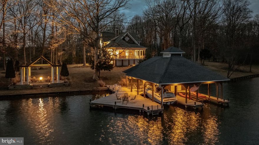 When you seek privacy, breathtaking lake views, exceptional waterfront amenities, and quality construction, The Peninsula at Lake Anna will be at the top of your list. Situated on the coveted Private Side of Lake Anna, this stunning 5,790-square-foot waterfront residence offers approximately 425 feet of pristine shoreline on a spectacular peninsula lot, creating panoramic water views in nearly every direction.

As you travel the long paved driveway, a sense of serenity and seclusion immediately takes hold. Nestled on approximately 1.5 acres, this remarkable property offers an unparalleled waterfront setting where spectacular sunrises, expansive water views, and the peaceful beauty of the lake become part of everyday life.

Inside, Southern charm meets timeless style. Natural light pours through expansive windows, framing breathtaking lake views from nearly every room. The thoughtfully designed floor plan provides ample space for both entertaining and everyday living, with multiple gathering areas that allow family and guests to come together while still enjoying private retreats throughout the home.

At the heart of the residence is an oversized kitchen with a generous walk-in pantry, offering abundant space for preparing meals, hosting celebrations, and creating lasting memories. Whether entertaining a crowd or enjoying a quiet evening at home, the home's seamless flow and waterfront backdrop create an extraordinary setting.

The spacious primary suite serves as a private sanctuary, featuring multiple closets and a well-appointed bath. Two additional upper-level bedrooms enjoy beautiful lake views, while the unique fourth bedroom is designed with a built-in raised sleeping platform and multiple adjoining sleeping areas, creating a wonderful space for children, grandchildren, guests, or multi-generational living.

The walkout lower level expands the home's versatility with a cozy den ideal for movie nights and gaming, a large flex room currently utilized as an office that could easily serve as an additional bedroom, and a spacious recreation area perfect for billiards, games, or entertaining. An unfinished nook offers the opportunity for a future kitchenette or bar area. Hobbyists and craftsmen will appreciate the dedicated two-room workshop with direct access to the attached two-car garage.

The outdoor living experience is equally impressive. Expansive decks and lakeside gathering areas invite you to relax and enjoy the magnificent waterfront setting. At the shoreline, a truly exceptional boathouse serves as the centerpiece of the property's waterfront lifestyle. Featuring two boat slips with lifts, a lakeside tiki bar, drop-down television, private storage room, and an expansive sun deck above, this waterfront retreat is designed for both relaxation and entertaining. Whether hosting family and friends, watching the big game after a day on the water, or enjoying a sunset cocktail overlooking the lake, this remarkable space elevates lake living to an entirely new level.

Additional features include an automated air injection oxidizing filtration system, whole-house particulate filtration system, and an active radon mitigation system already in place.

Rarely does a property combine such exceptional waterfront, privacy, entertaining spaces, and family-friendly accommodations in one offering. The Peninsula at Lake Anna presents a unique opportunity to create lasting memories in one of the lake's most extraordinary waterfront settings.