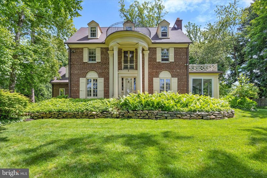 Welcome to this classic Wallace & Warner Wayne home just blocks from the center of town.  Lovingly cared for and beautifully updated by the current owners who have renovated the kitchen, updated the originals and added 2 bathrooms,  created a comfortable gathering room and built  an oversized garage with additional storage.   The expansive entrance foyer features a front door with sidelights, extensive moldings, hardwood floors and a coat closet.  The living room with wood floors features a wood burning fireplace, built-in bookcase and French doors opening to a Juliet balcony which overlooks the front yard.  French doors lead to a 3 season room with floor to ceiling windows and sliding doors on three sides which allows access to the front,side and back yards.  The dining room located off the foyer has hardwood floors, French doors leading to a second Juliet Balcony and wall mounted lighting. Entering the kitchen area there is a nook with built-in seating accented with display cabinetry, a ceiling fan and another set of cabinets with a granite counter next to the entrance to the dining room.  The kitchen, features wood floors, an island with pendant lights and room for seating, neutral cabinets by Kitchen Kraft, granite countertops, an architectural style hood, a farm sink, oversized windows, pantry, steps accessing the main staircase up to second floor, recessed lights and stainless steel appliances.  The adjacent gathering room has a gas fireplace, an abundance of built-ins, recessed lighting, wood floors and a wall of windows with transoms and a pair of french doors. A covered back door entrance with a keyless entry system, natural stone  tile floors,  built in cubbies and a charming powder room complete this level.  The second level features a spacious in-law or au pair suite with room for a seating area and/or office with built-in bookcase and closet. The bedroom features 3 large windows along one wall and an en-suite bath with marble molding accents in the shower and a vanity with a marble top. There are treetop views in both rooms of this suite.  A second bedroom with wood floors, shelving and in-room (direct) access to the full bath with tub and shower with sliding doors, subway tile and tile corner shelving.  The primary suite features a dressing room with an abundance of closets and access to the hallway, a large bedroom with moldings and windows facing the front and side yards. The ensuite primary bath has a generous shower, a wooden double sink vanity with rubbed bronze fixtures, built-in mirror with accent tile framing and natural stone floors.  The third floor has a built-in vanity with storage next to the full bathroom. This bathroom features  sea glass accents and mosaic detail in the ceramic floor.  A fourth bedroom features a window seat, dormer windows and a built-in bookcase.  The large 5th bedroom at the end of the hall has a generous wall of windows over a built-in bookcase, wood floors and completes this floor.  The Lower Level, accessed through the kitchen, has a spacious, open, multi-purpose space with walls of shelving and new flooring.  The laundry room is large with more shelving.  In addition, there is access through Bilco doors to the backyard. The utility room includes the heating system, tankless hot water and additional storage options.  The spacious back yard is truly an oasis accented with mature plantings and a slate seating area.  It offers a space not easily viewed from the front of the property. The oversized 2 car garage with an additional side door access also has pulldown steps that lead to  storage space.